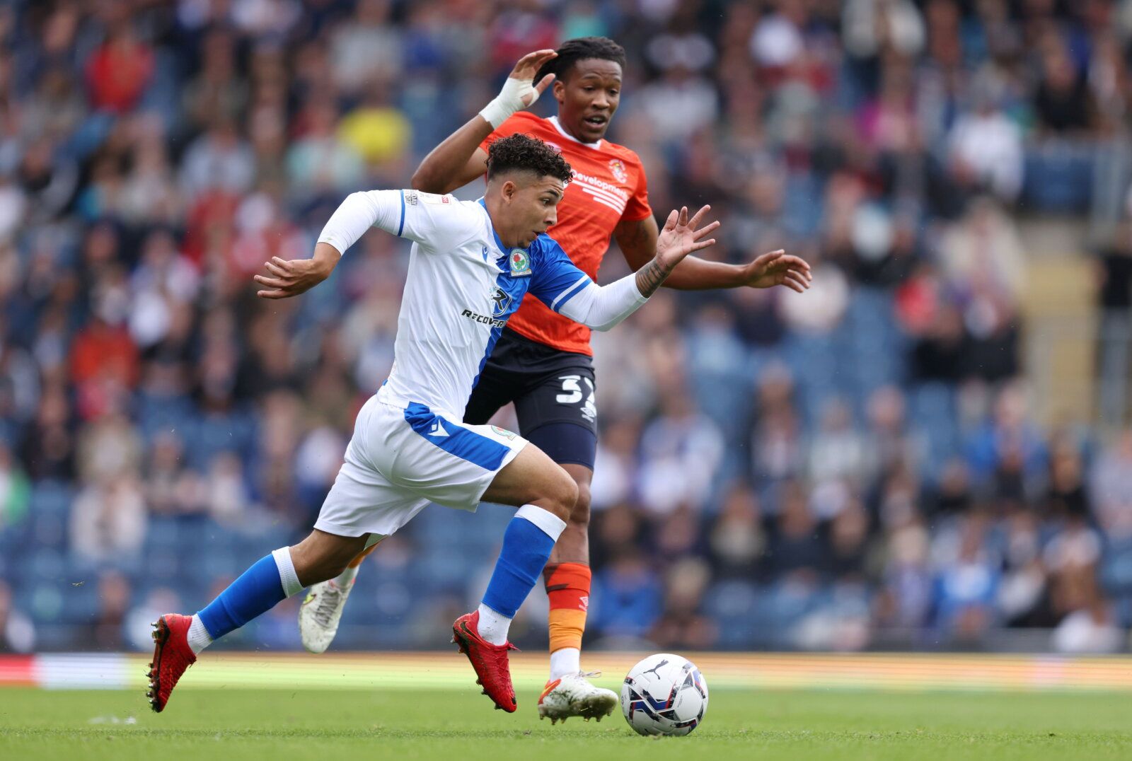 Soccer Football - Championship - Blackburn Rovers v Luton Town - Ewood Park, Blackburn, Britain - September 11, 2021  Blackburn Rovers' Tyrhys Dolan in action with Luton Town's Gabriel Osho  Action Images/John Clifton  EDITORIAL USE ONLY. No use with unauthorized audio, video, data, fixture lists, club/league logos or "live" services. Online in-match use limited to 75 images, no video emulation. No use in betting, games or single club/league/player publications.  Please contact your account repr