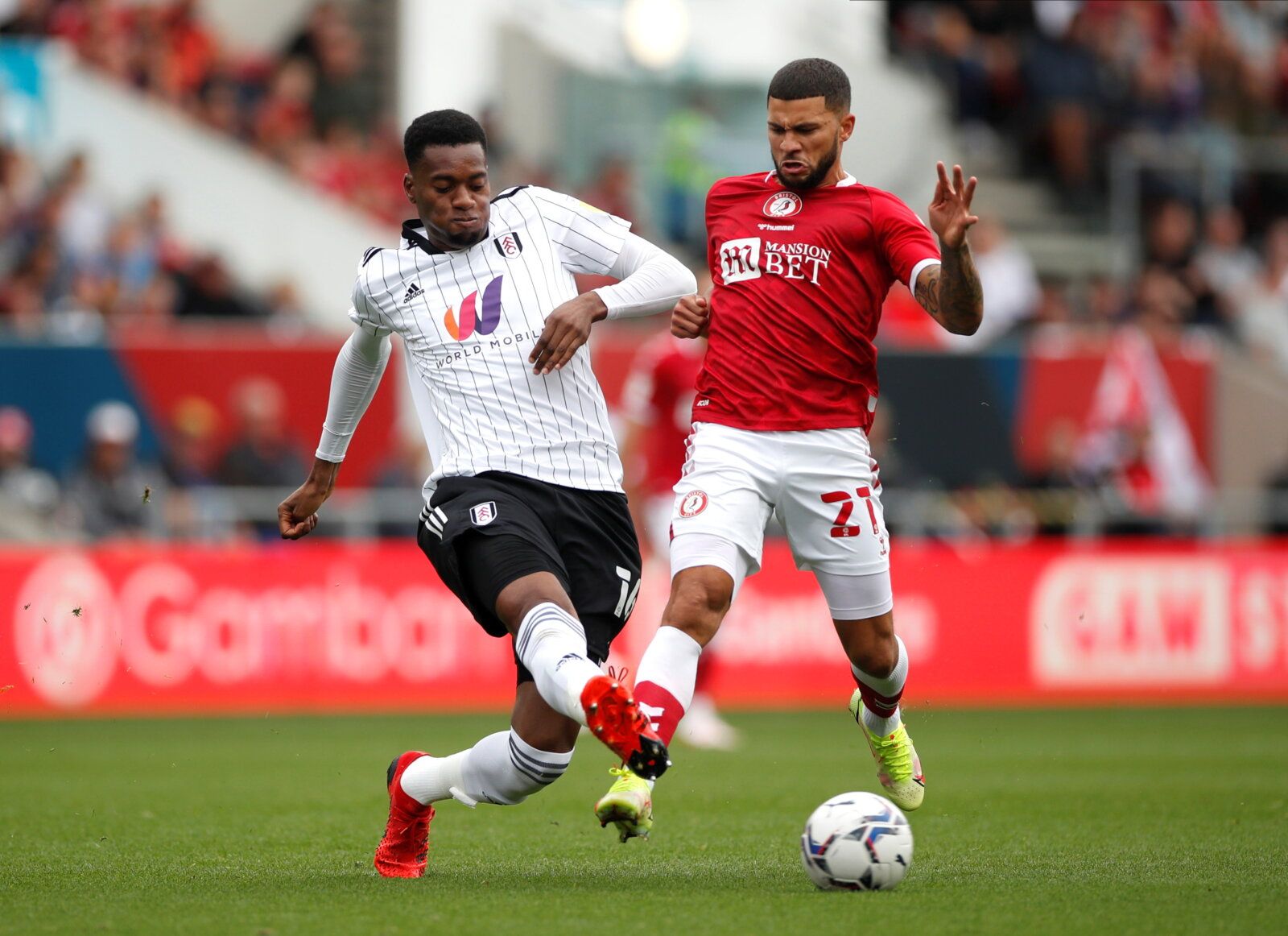 Soccer Football - Championship - Bristol City v Fulham - Ashton Gate Stadium, Bristol, Britain - September 25, 2021  Fulham's Tosin in action with Bristol City's Nahki Wells  Action Images/Paul Childs  EDITORIAL USE ONLY. No use with unauthorized audio, video, data, fixture lists, club/league logos or 