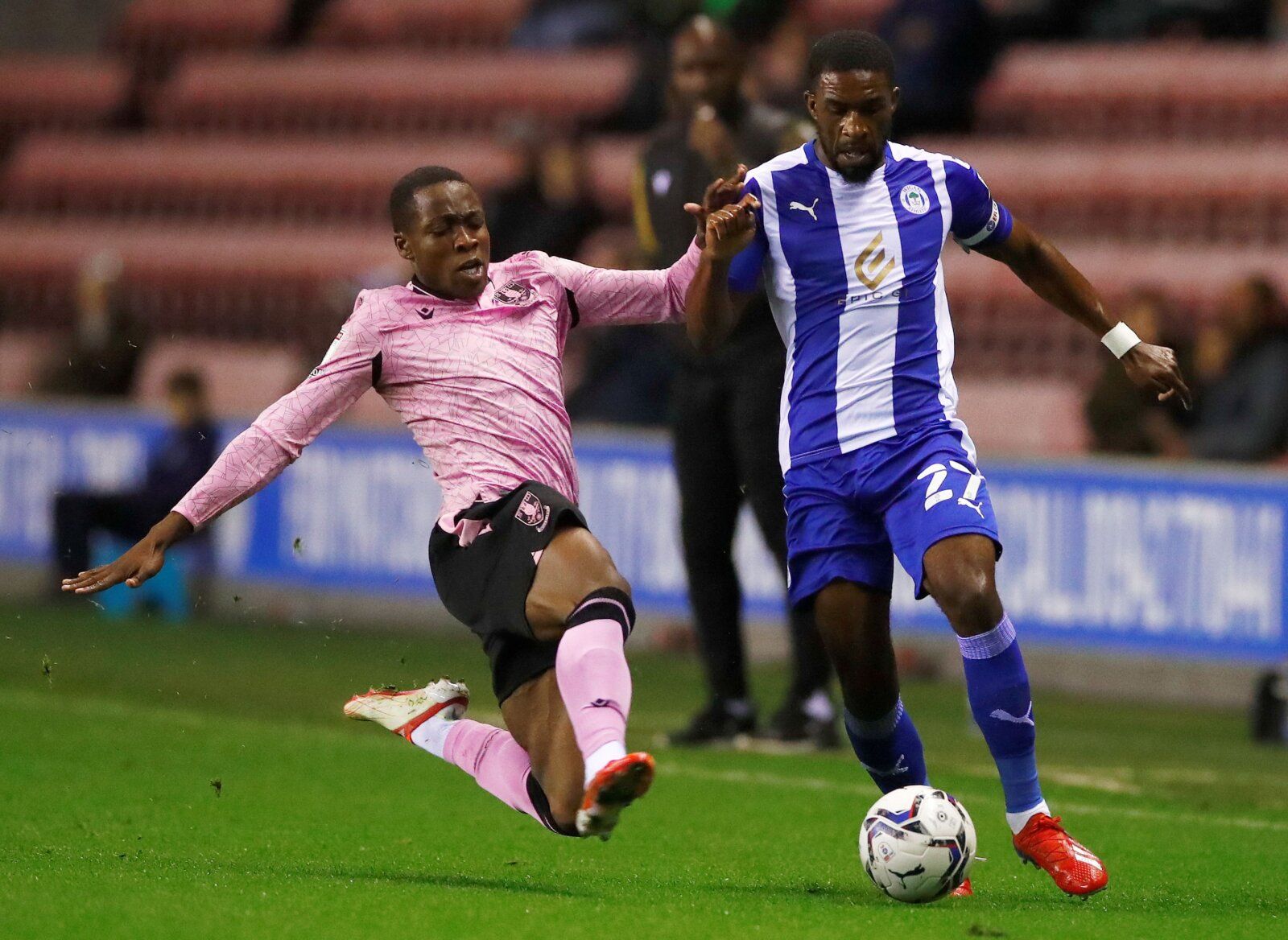 Soccer Football - League One - Wigan Athletic v Sheffield Wednesday - DW Stadium, Wigan, Britain - September 28, 2021 Sheffield Wednesday's Dennis Adeniran in action with Wigan Athletic's Tendayi Darikwa   Action Images/Jason Cairnduff  EDITORIAL USE ONLY. No use with unauthorized audio, video, data, fixture lists, club/league logos or "live" services. Online in-match use limited to 75 images, no video emulation. No use in betting, games or single club/league/player publications.  Please contact