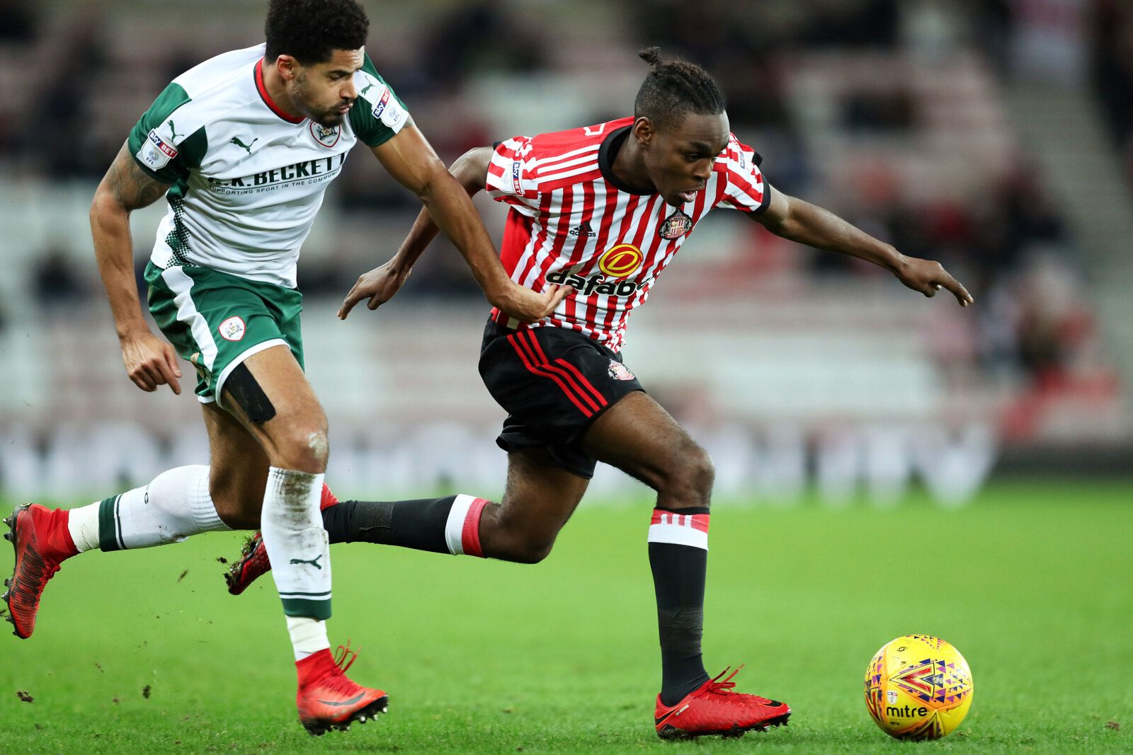 Soccer Football - Championship - Sunderland vs Barnsley - Stadium of Light, Sunderland, Britain - January 1, 2018   Sunderland’s Joel Asoro in action with Barnsley’s Ezekiel Fryers   Action Images/John Clifton    EDITORIAL USE ONLY. No use with unauthorized audio, video, data, fixture lists, club/league logos or 