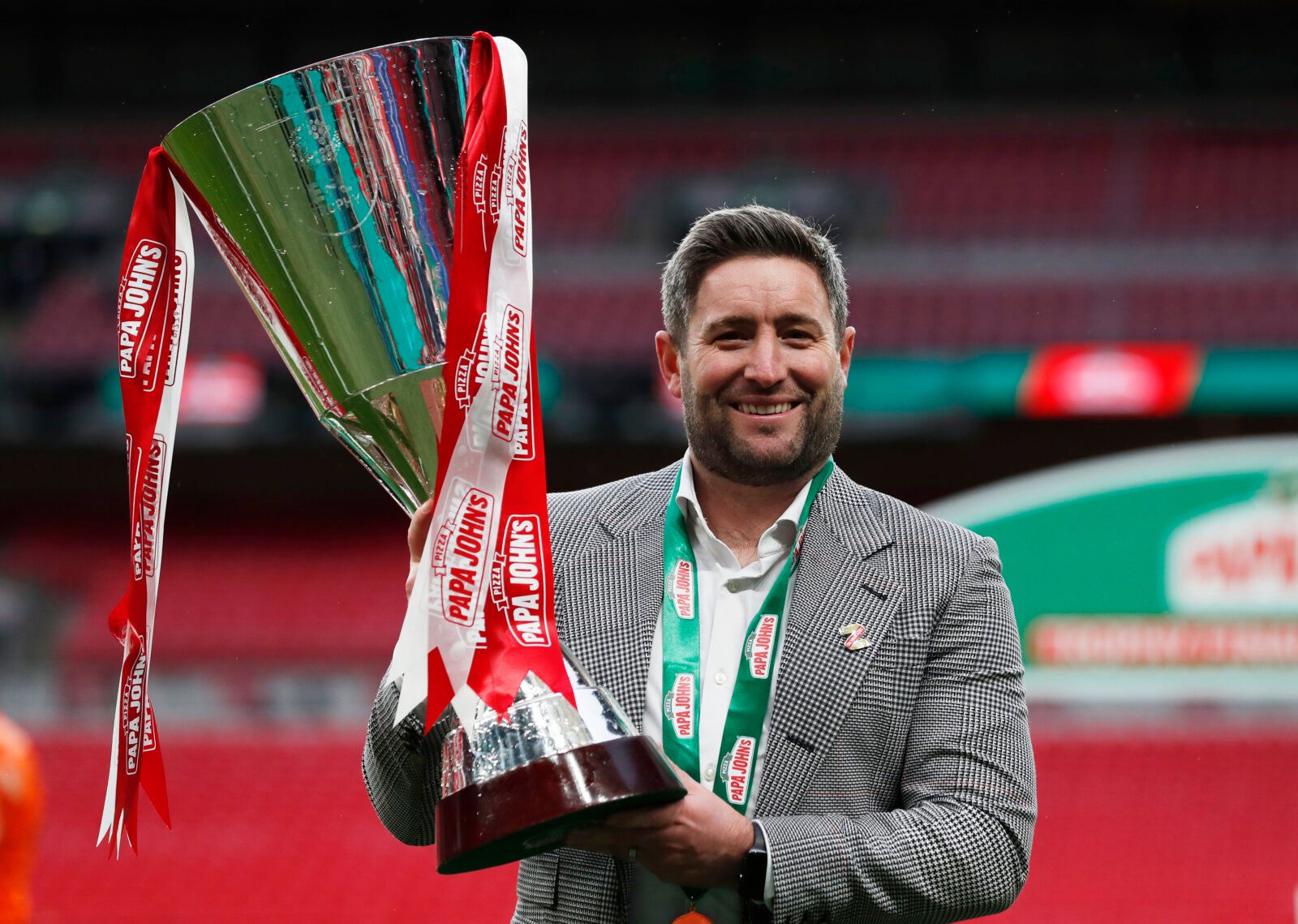 Soccer Football - EFL Trophy Final - Sunderland v Tranmere Rovers - Wembley Stadium, London, Britain - March 14, 2021 Sunderland manager Lee Johnson celebrates with the EFL Trophy after the match Action Images/Lee Smith EDITORIAL USE ONLY. No use with unauthorized audio, video, data, fixture lists, club/league logos or 'live' services. Online in-match use limited to 75 images, no video emulation. No use in betting, games or single club /league/player publications.  Please contact your account re