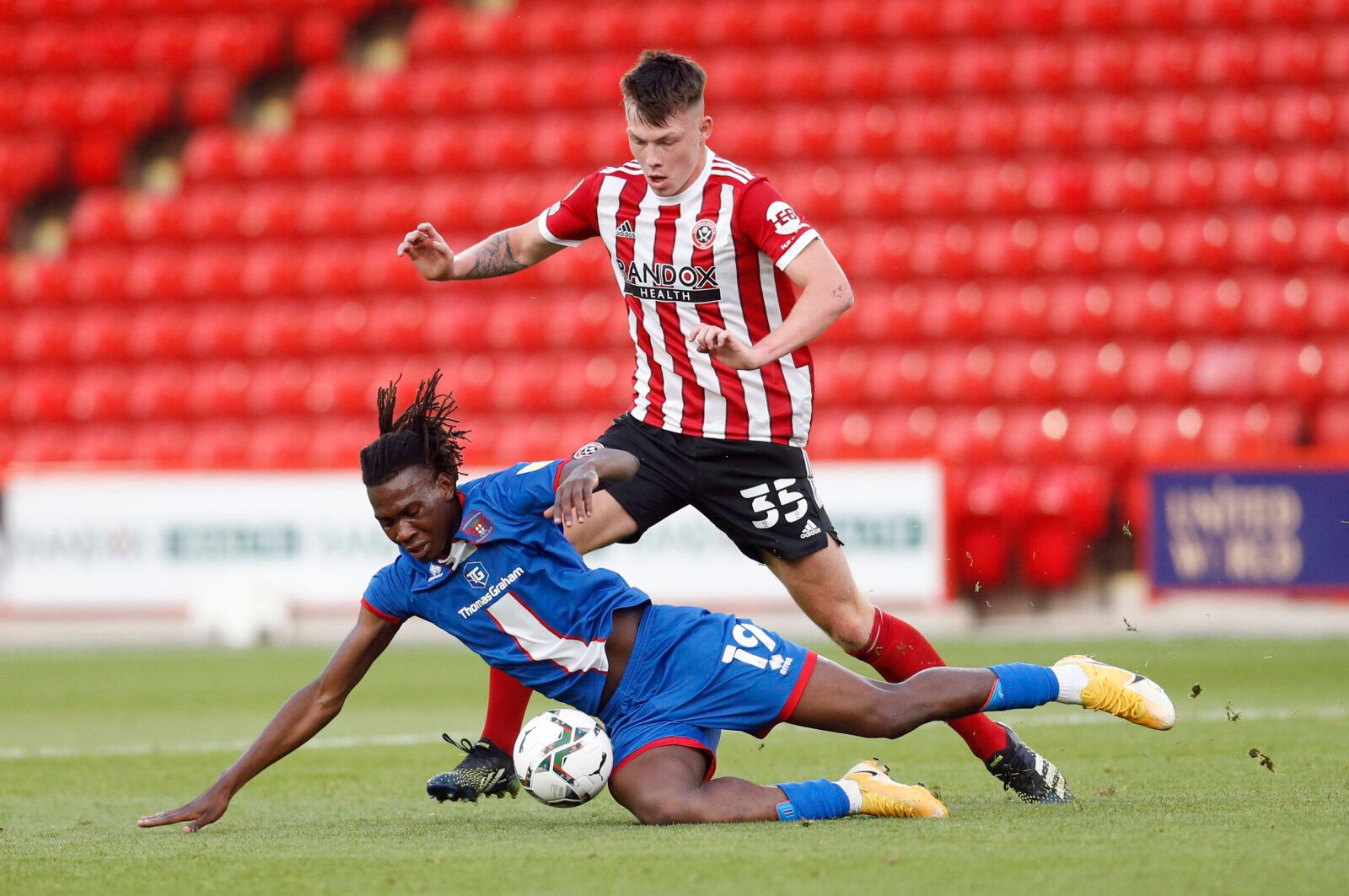 Soccer Football - Carabao Cup - First Round - Sheffield United v Carlisle United - Bramall Lane, Sheffield, Britain - August 10, 2021 Carlisle United's Manasse Mampala and Sheffield United's Kacper Lopata in action Action Images/Ed Sykes EDITORIAL USE ONLY. No use with unauthorized audio, video, data, fixture lists, club/league logos or 'live' services. Online in-match use limited to 75 images, no video emulation. No use in betting, games or single club /league/player publications.  Please conta