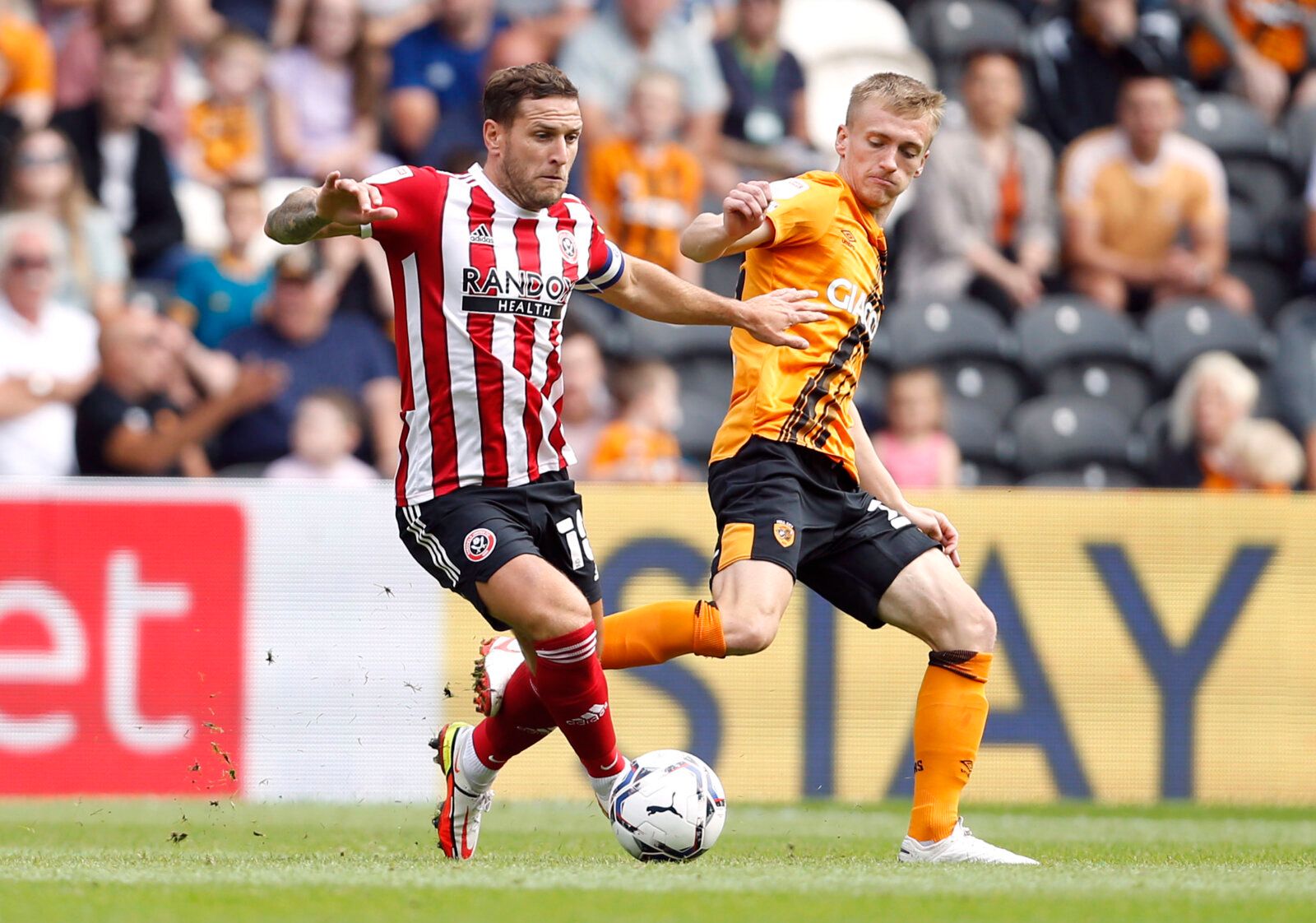 Soccer Football - Championship - Hull City v Sheffield United - KCOM Stadium, Hull, Britain - September 18, 2021 Sheffield United's Billy Sharp in action with Hull City's Matt Smith Action Images/Ed Sykes EDITORIAL USE ONLY. No use with unauthorized audio, video, data, fixture lists, club/league logos or 'live' services. Online in-match use limited to 75 images, no video emulation. No use in betting, games or single club /league/player publications.  Please contact your account representative fo