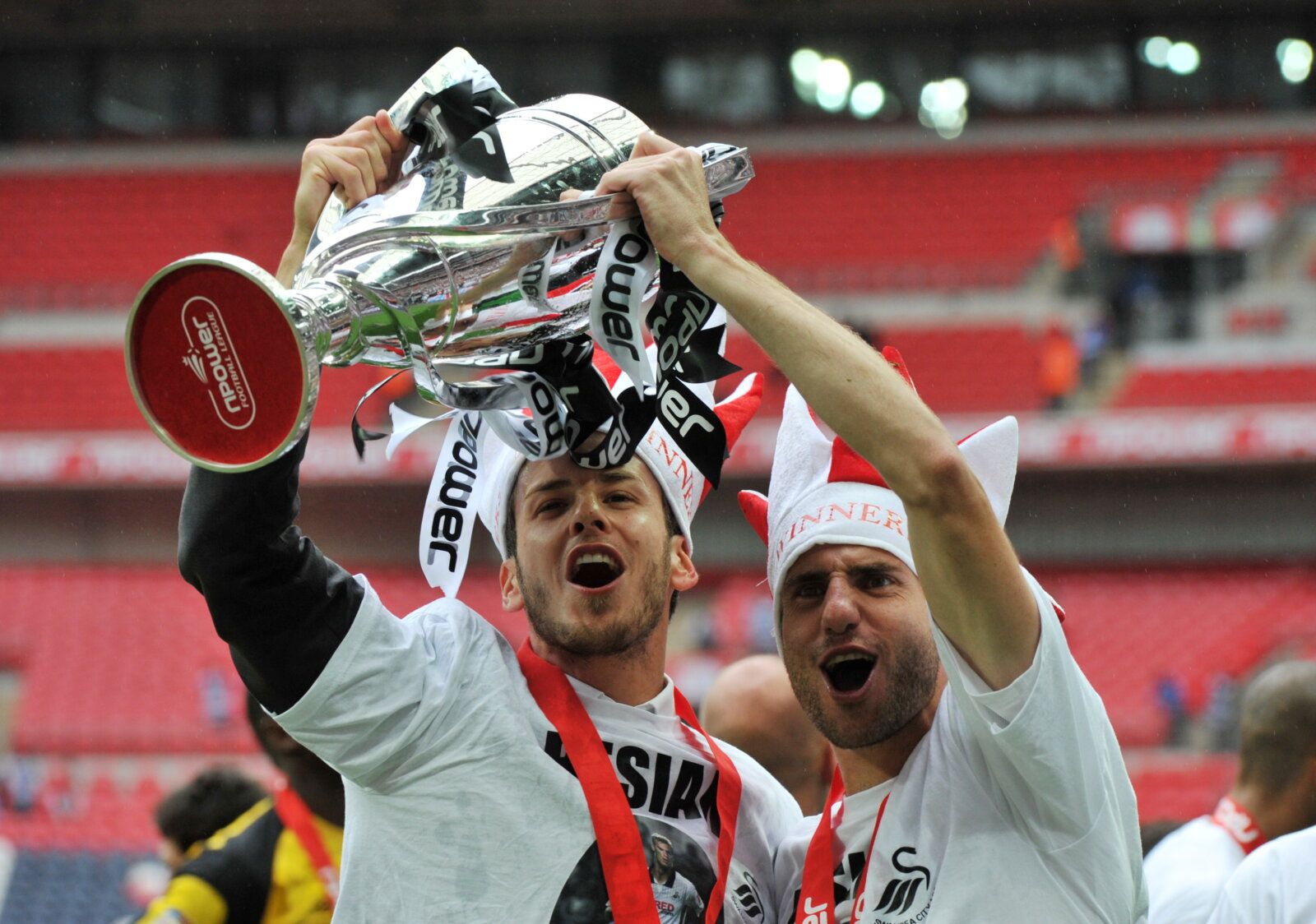 Football - Reading v Swansea City - npower Football League Championship Play-Off Final - Wembley Stadium - 10/11 - 30/5/11 
Swansea City's Andrea Orlandi (L) and Angel Rangel (R) celebrate winning the Championship Play Off Final with the trophy 
Mandatory Credit: Action Images / Adam Holt