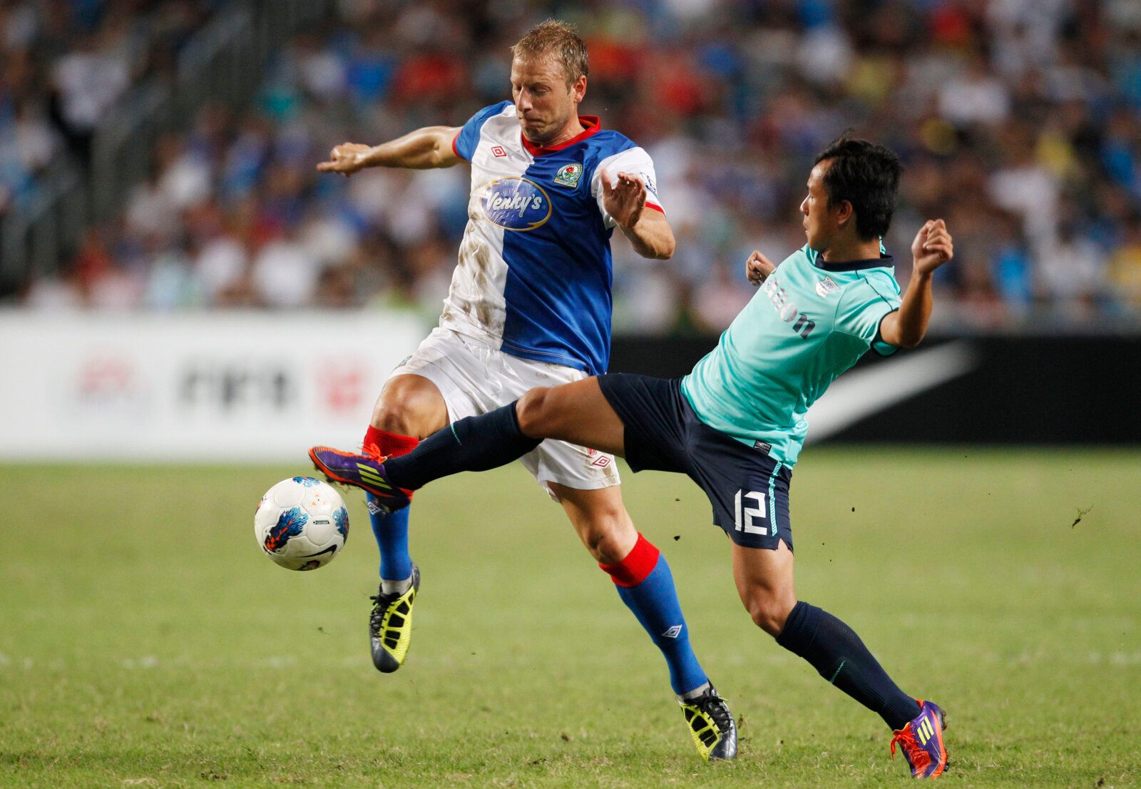 Football - Kitchee v Blackburn Rovers Barclays Asia Trophy Third/Fourth Place Play-Off - Hong Kong 2011  - The Hong Kong Stadium - 30/7/11 
Blackburn Rovers' Vince Grella and Kitchee's Lo Kwan Yee (R) in action 
Mandatory Credit: Action Images / John Sibley 
Livepic