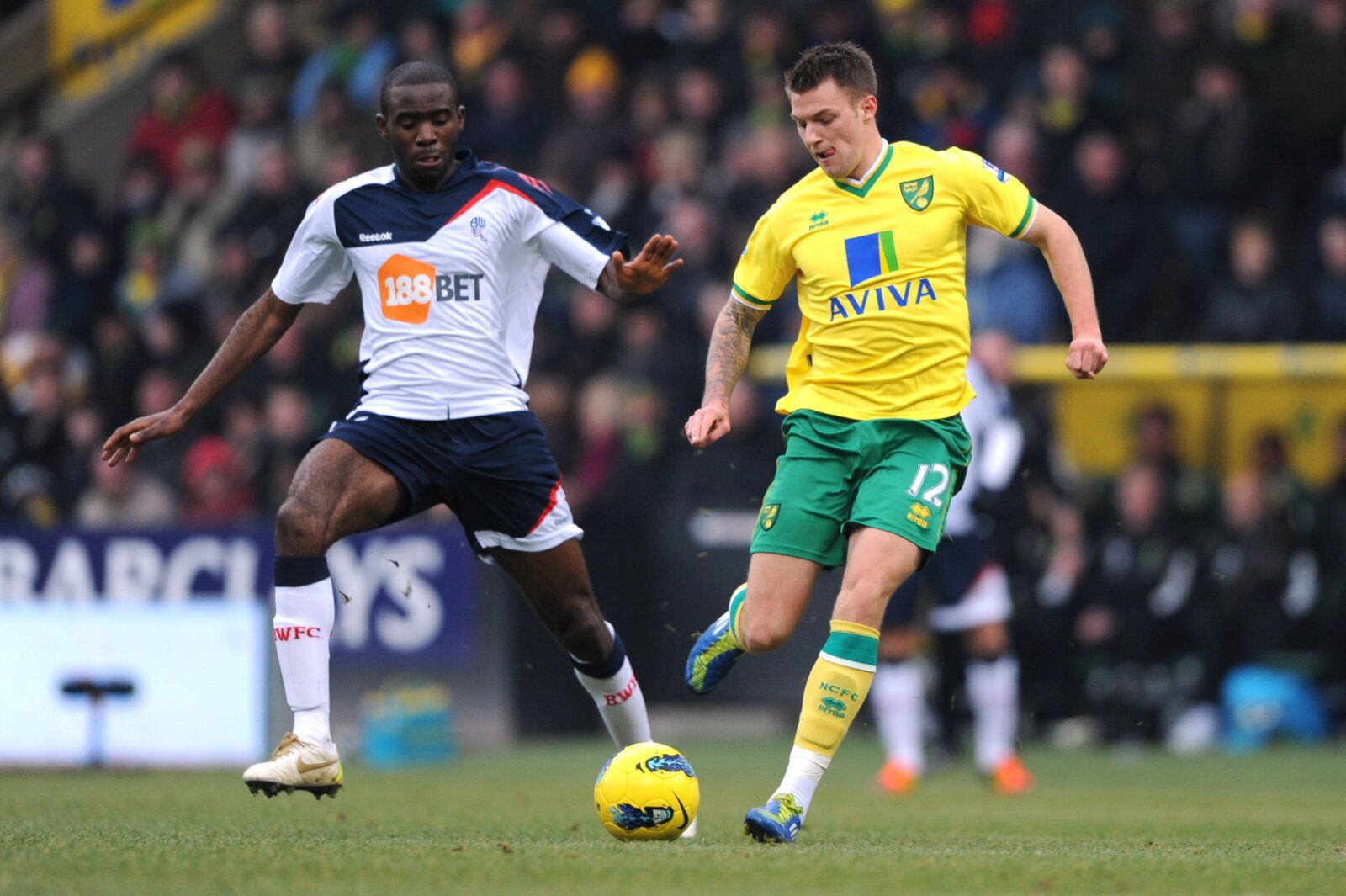 Football - Norwich City v Bolton Wanderers Barclays Premier League - Carrow Road - 11/12 - 4/2/12 
Anthony Pilkington - Norwich City in action against Fabrice Muamba - Bolton Wanderers (L) 
Mandatory Credit: Action Images / Henry Browne 
EDITORIAL USE ONLY. No use with unauthorized audio, video, data, fixture lists, club/league logos or live services. Online in-match use limited to 45 images, no video emulation. No use in betting, games or single club/league/player publications.  Please contact 