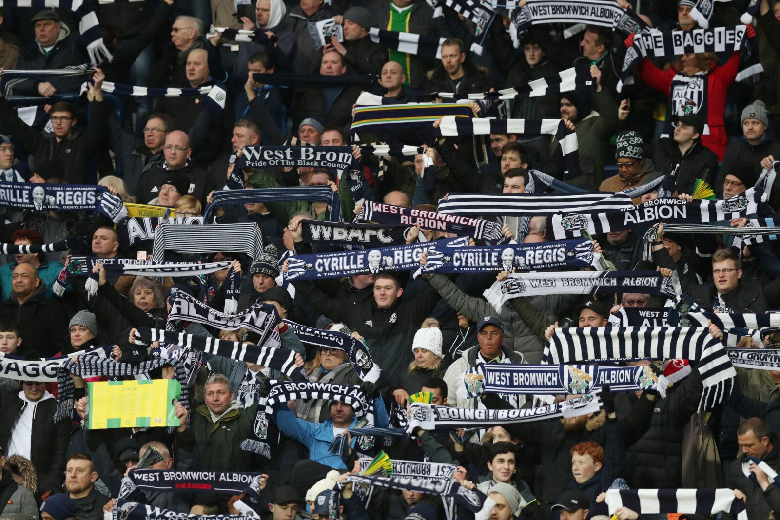 Soccer Football - Premier League - West Bromwich Albion vs Southampton - The Hawthorns, West Bromwich, Britain - February 3, 2018   West Brom fans raise scarves in remembrance of Cyrille Regis   Action Images via Reuters/Peter Cziborra    EDITORIAL USE ONLY. No use with unauthorized audio, video, data, fixture lists, club/league logos or 