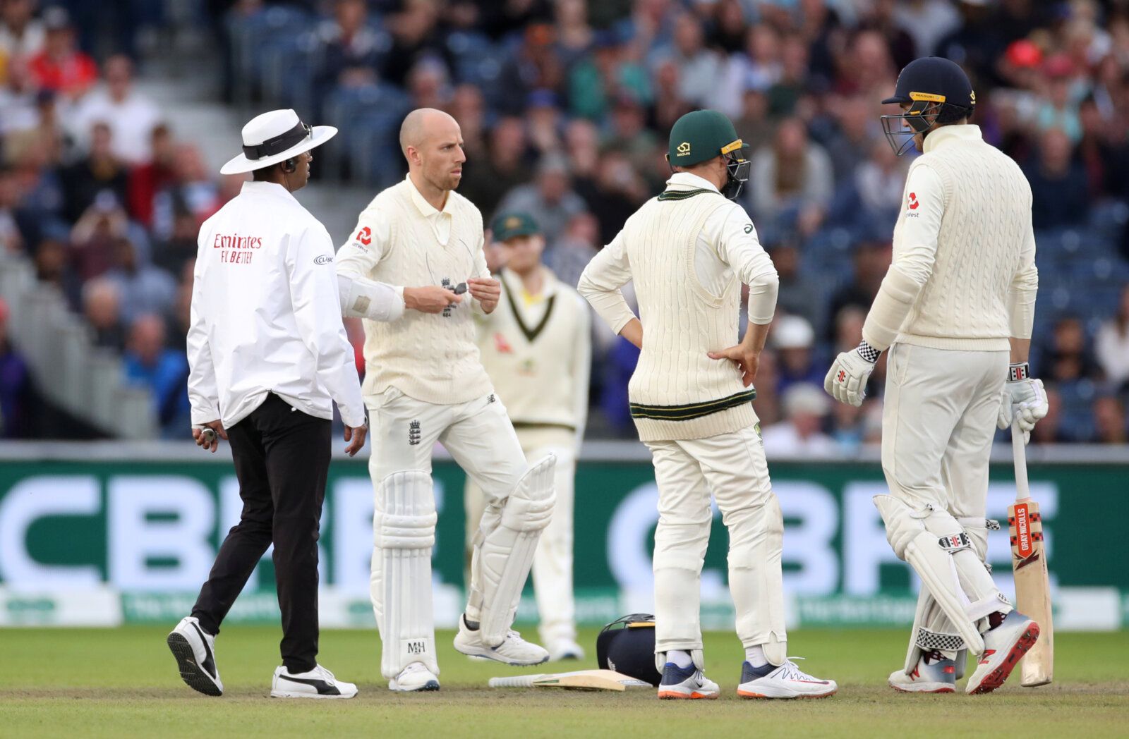 Cricket - Ashes 2019 - Fourth Test - England v Australia - Emirates Old Trafford, Manchester, Britain - September 8, 2019   England's Jack Leach cleans his glasses after the ball hit his helmet during the match    Action Images via Reuters/Carl Recine