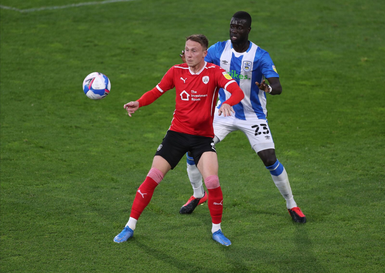 Soccer Football - Championship - Huddersfield Town v Barnsley - John Smith's Stadium, Huddersfield, Britain - April 21, 2021 Huddersfield Town's Nabby Sarr in action with Barnsley's Cauley Woodrow Action Images/Lee Smith EDITORIAL USE ONLY. No use with unauthorized audio, video, data, fixture lists, club/league logos or 'live' services. Online in-match use limited to 75 images, no video emulation. No use in betting, games or single club /league/player publications.  Please contact your account r