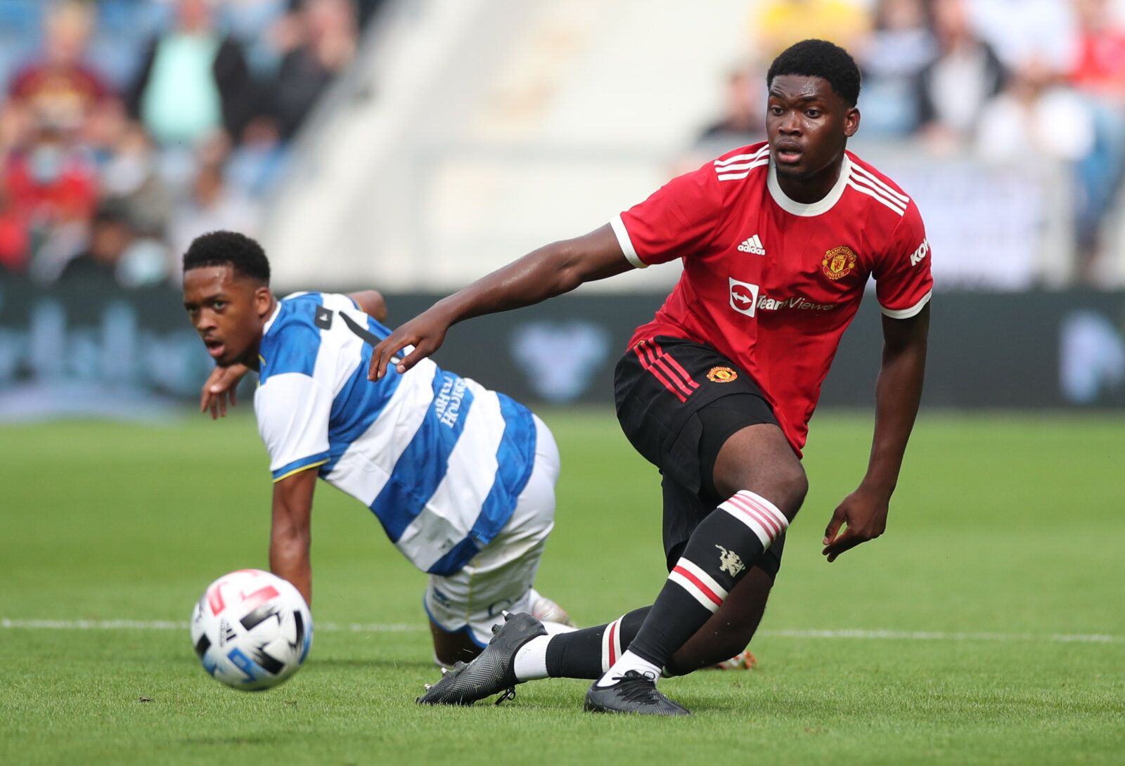 Soccer Football - Pre Season Friendly - Queens Park Rangers v Manchester United - Loftus Road. London, Britain - July 24, 2021 Manchester United's Teden Mengi in action with Queens Park Rangers' Chris Willock Action Images via Reuters/Peter Cziborra