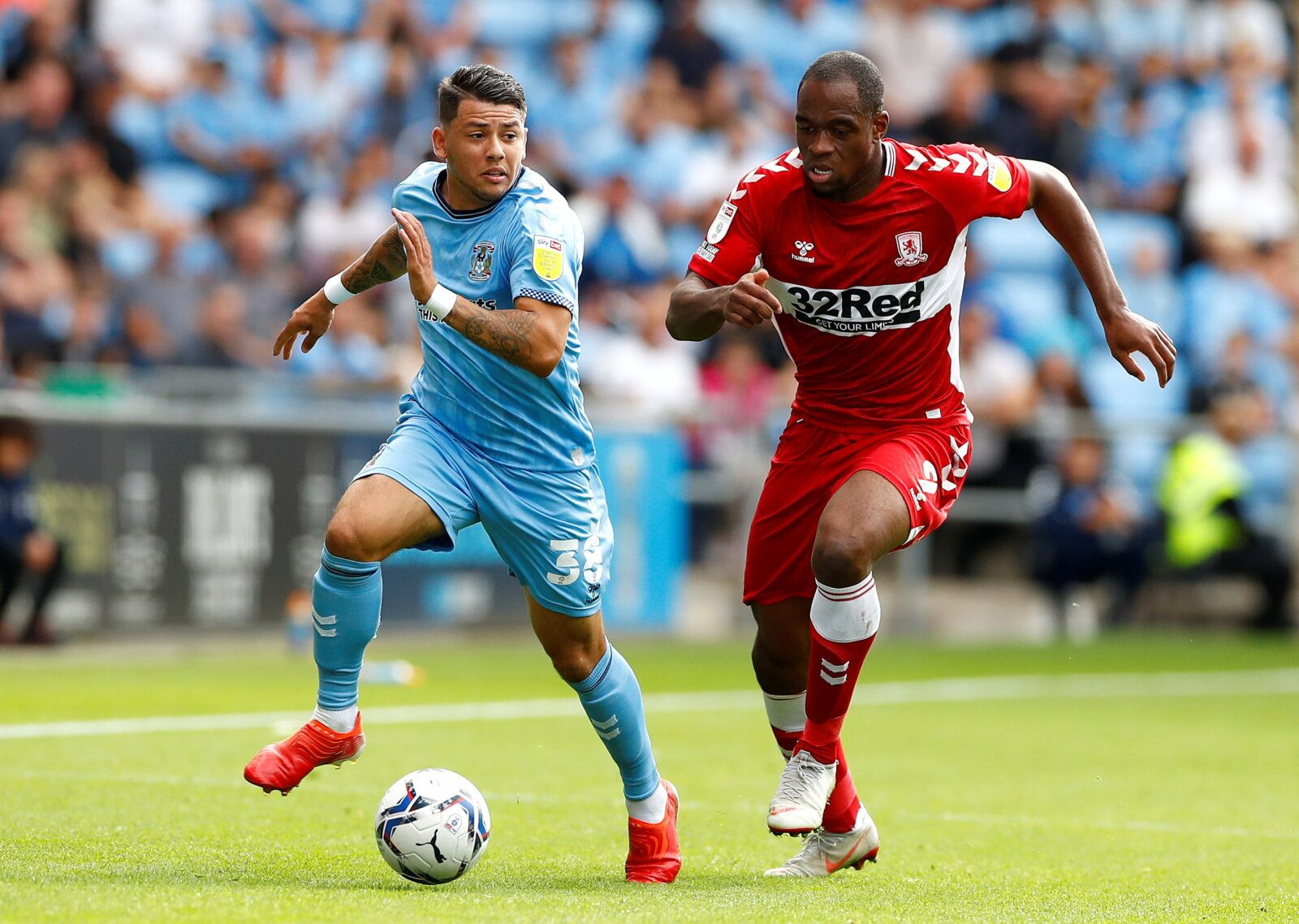 Soccer Football - Championship - Coventry City v Middlesbrough - Coventry Building Society Arena, Coventry, Britain - September 11, 2021  Coventry City's Gustavo Hamer in action with Middlesbrough's Uche Ikpeazu  Action Images/Jason Cairnduff  EDITORIAL USE ONLY. No use with unauthorized audio, video, data, fixture lists, club/league logos or "live" services. Online in-match use limited to 75 images, no video emulation. No use in betting, games or single club/league/player publications.  Please 