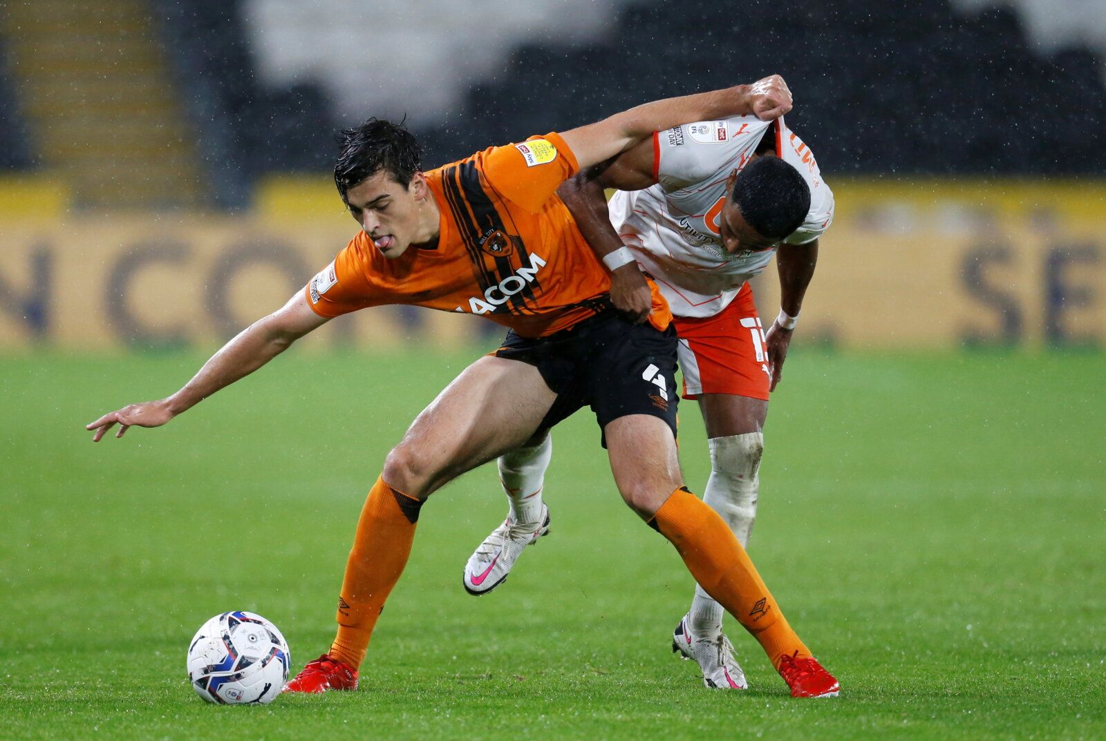 Soccer Football - Championship - Hull City v Blackpool - KCOM Stadium, Hull, Britain - September 28, 2021  Hull City's Jacob Greaves in action with Blackpool's Demetri Mitchell  Action Images/Ed Sykes  EDITORIAL USE ONLY. No use with unauthorized audio, video, data, fixture lists, club/league logos or "live" services. Online in-match use limited to 75 images, no video emulation. No use in betting, games or single club/league/player publications.  Please contact your account representative for fu