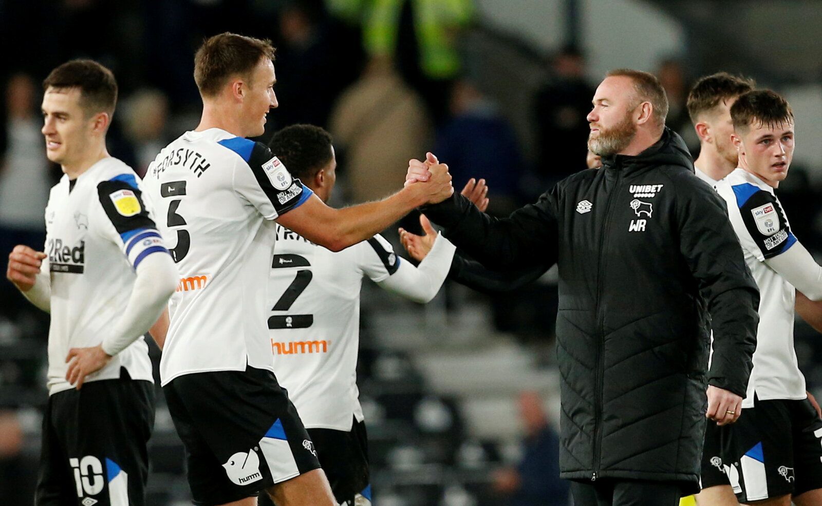 Soccer Football - Championship - Derby County v Reading - Pride Park, Derby, Britain - September 29, 2021 Derby County manager Wayne Rooney shakes hands with Craig Forsyth after the match Action Images/Craig Brough  EDITORIAL USE ONLY. No use with unauthorized audio, video, data, fixture lists, club/league logos or 