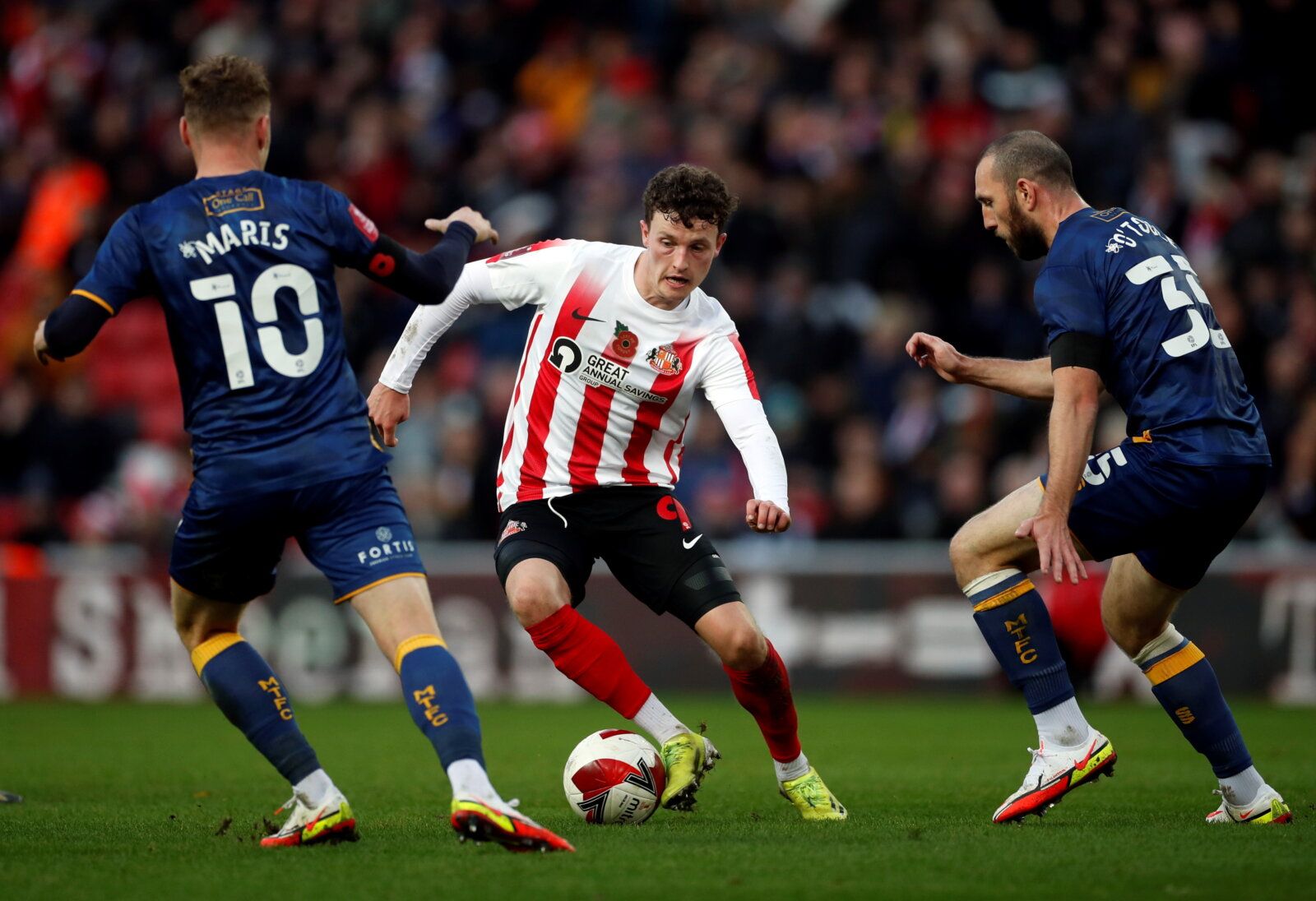 Soccer Football - FA Cup - First Round - Sunderland v Mansfield Town - Stadium of Light, Sunderland, Britain - November 6, 2021 Mansfield Town's George Maris and John Joe Toole in action with Sunderland’s Nathan Broadhead   Action Images/Lee Smith