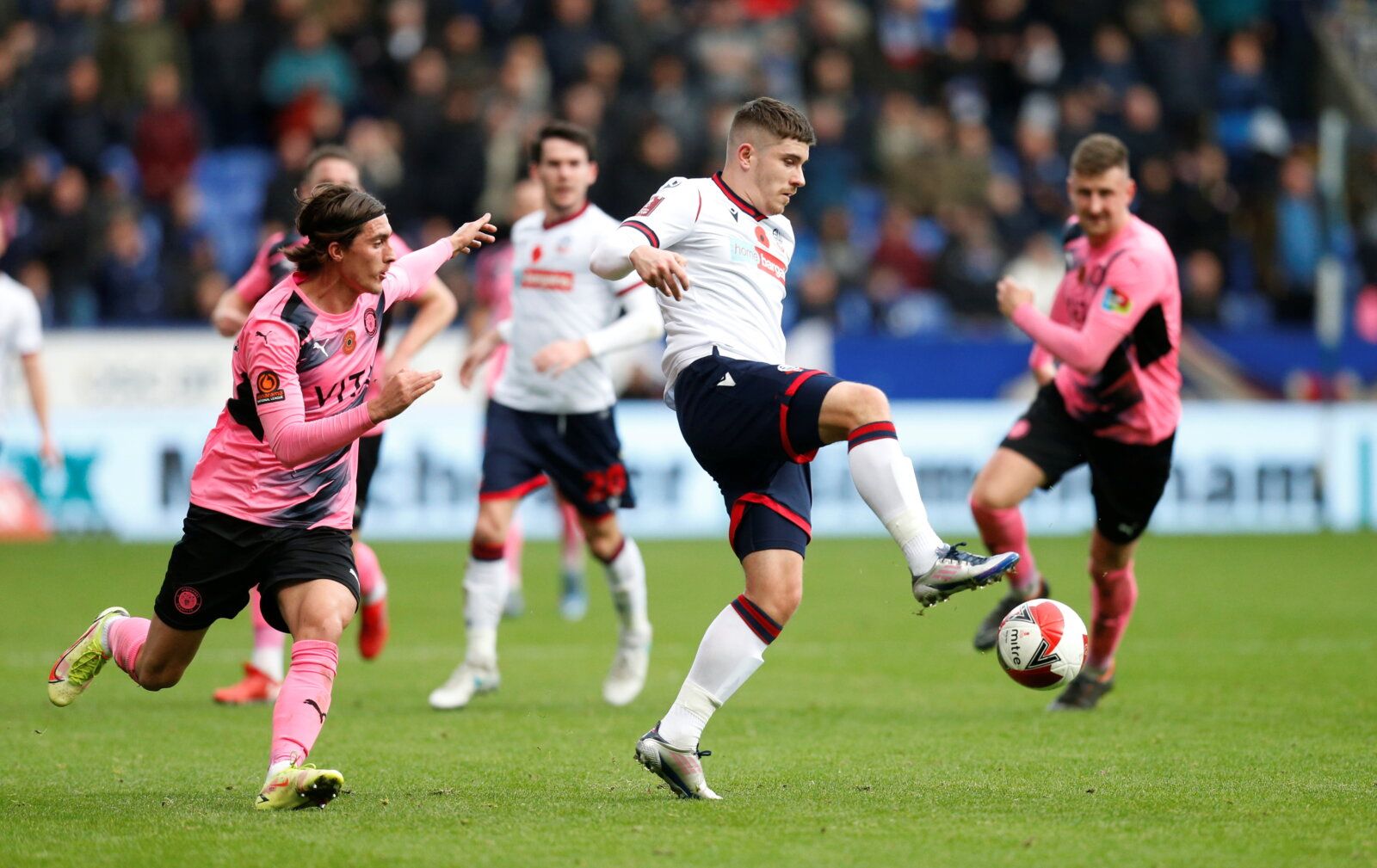 Soccer Football - FA Cup - First Round - Bolton Wanderers v Stockport County - University of Bolton Stadium, Bolton, Britain - November 7, 2021 Bolton Wanderers' Declan John in action with Stockport County's Ollie Crankshaw