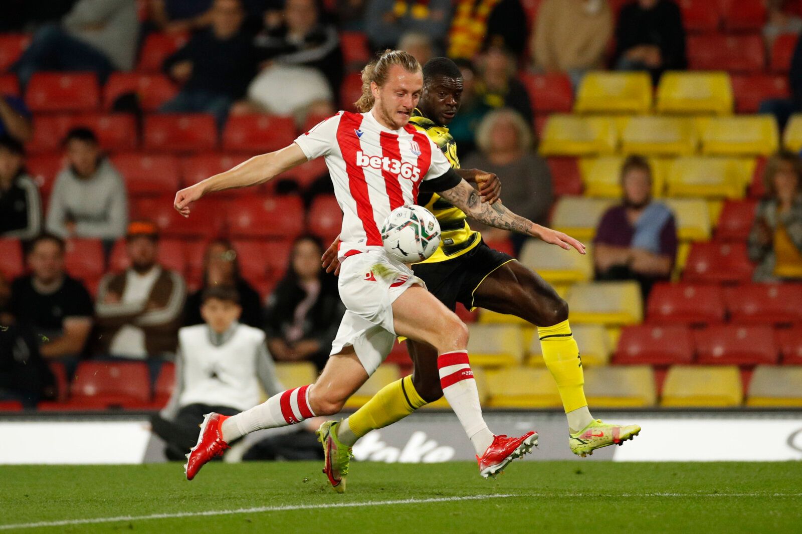 Soccer Football - Carabao Cup - Third Round - Watford v Stoke City - Vicarage Road, Watford, Britain - September 21, 2021 Stoke's Ben Wilmot in action with Watford's Ken Sema Action Images via Reuters/Andrew Boyers EDITORIAL USE ONLY. No use with unauthorized audio, video, data, fixture lists, club/league logos or 'live' services. Online in-match use limited to 75 images, no video emulation. No use in betting, games or single club /league/player publications.  Please contact your account represe