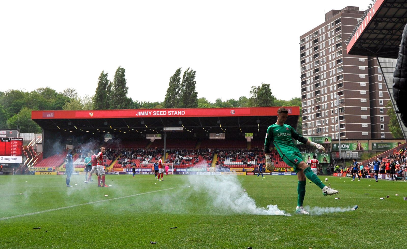 Britain Football Soccer - Charlton Athletic v Swindon Town - Sky Bet League One - The Valley - 30/4/17 Charlton Athletic's Declan Rudd clears a flare as fans protest with balloons and flares against owner Roland Duchatelet before the game Mandatory Credit: Action Images / Adam Holt Livepic EDITORIAL USE ONLY. No use with unauthorized audio, video, data, fixture lists, club/league logos or 