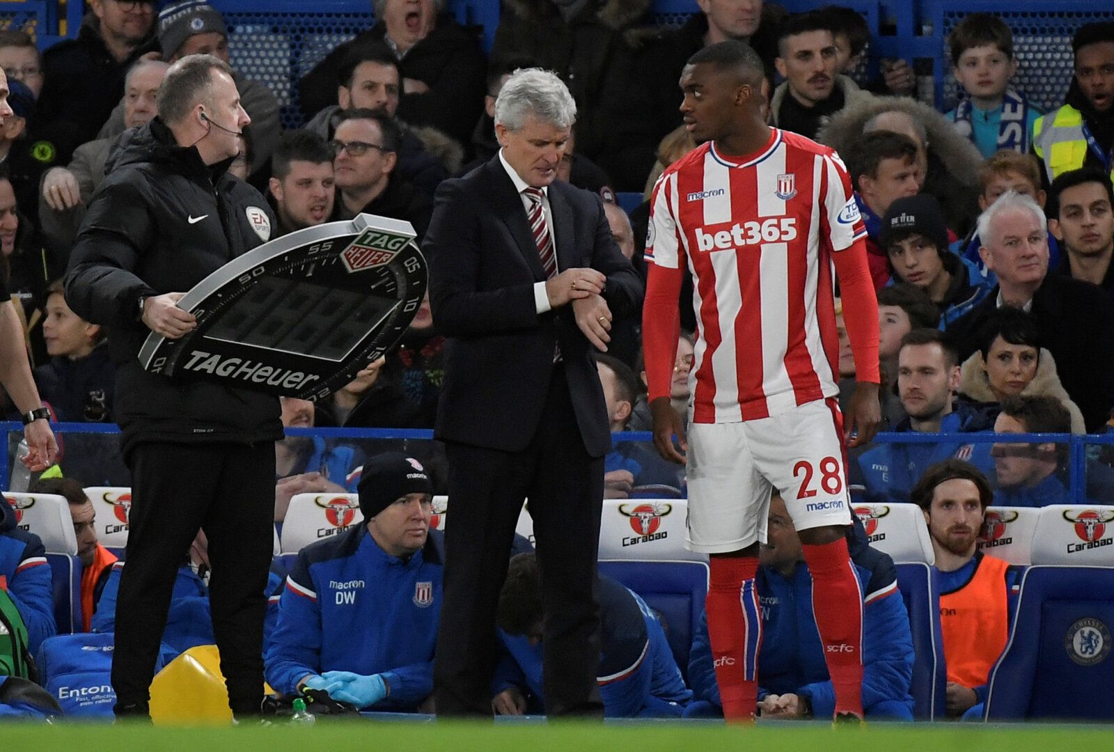 Soccer Football - Premier League - Chelsea vs Stoke City - Stamford Bridge, London, Britain - December 30, 2017   Stoke City's Julien Ngoy talks to manager Mark Hughes as he prepares to come on                 REUTERS/Toby Melville    EDITORIAL USE ONLY. No use with unauthorized audio, video, data, fixture lists, club/league logos or 