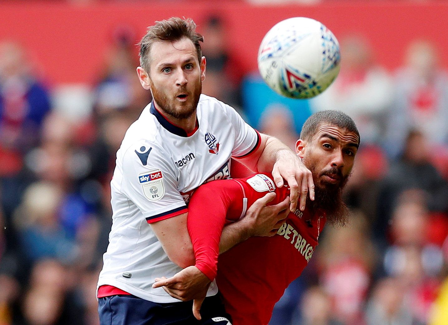 Soccer Football - Championship - Nottingham Forest v Bolton Wanderers - The City Ground, Nottingham, Britain - May 5, 2019   Nottingham Forest's Lewis Grabban in action with Bolton Wanderers' Jonathan Grounds   Action Images/Peter Cziborra    EDITORIAL USE ONLY. No use with unauthorized audio, video, data, fixture lists, club/league logos or "live" services. Online in-match use limited to 75 images, no video emulation. No use in betting, games or single club/league/player publications.  Please c