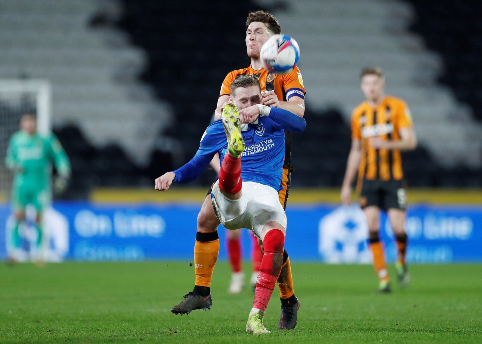 Soccer Football - League One - Hull City v Portsmouth- KCOM Stadium, Hull, Britain - December 18, 2020  Hull City's Richard Smallwood in action with Portsmouth's Ronan Curtis   Action Images/Lee Smith  EDITORIAL USE ONLY. No use with unauthorized audio, video, data, fixture lists, club/league logos or 