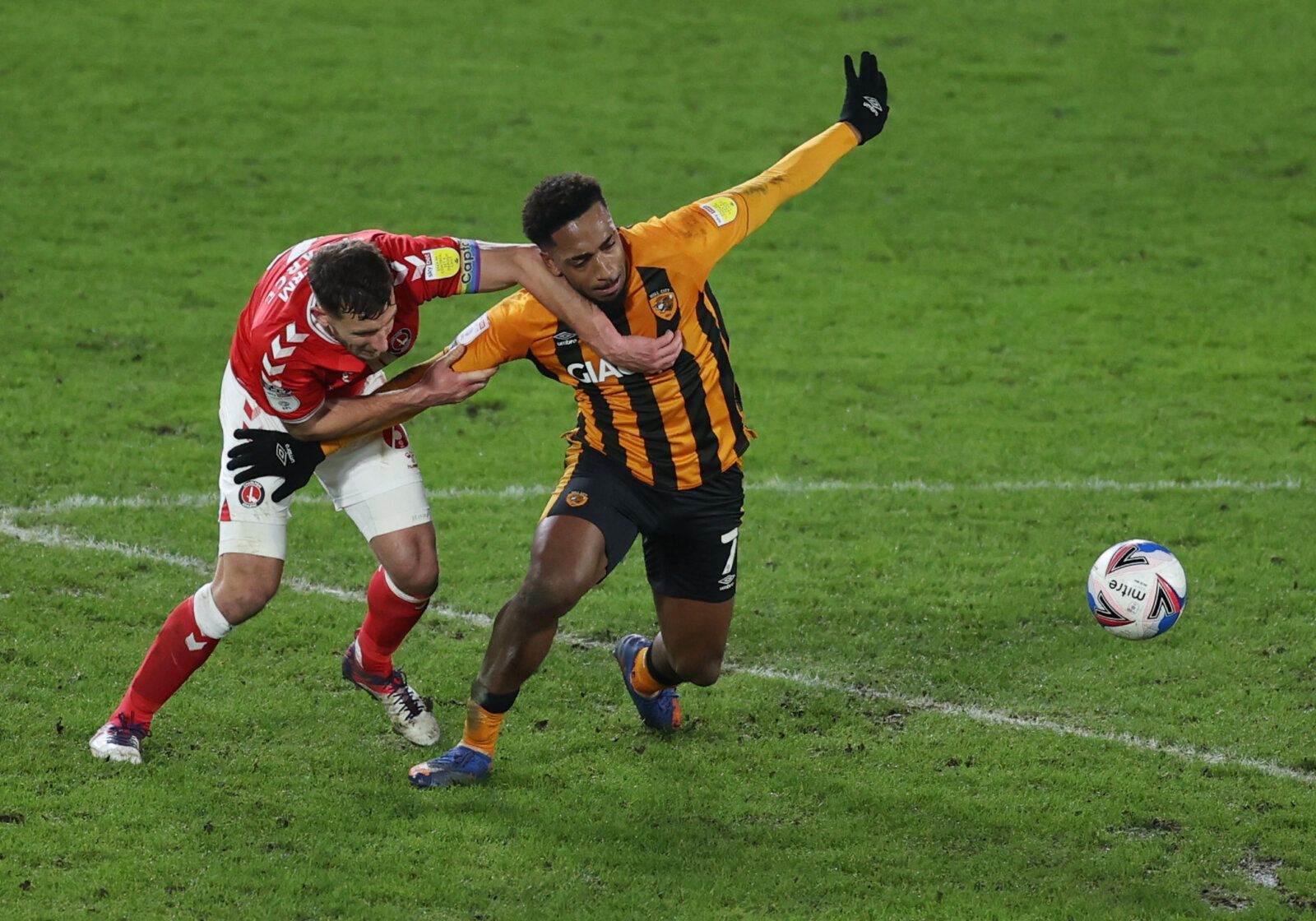 Soccer Football - League One - Hull City v Charlton Athletic - KCOM Stadium, Hull, Britain - January 2, 2021 Hull City's Malik Wilks in action with Charlton Athletic's Jason Pearce Action Images/Lee Smith EDITORIAL USE ONLY. No use with unauthorized audio, video, data, fixture lists, club/league logos or 'live' services. Online in-match use limited to 75 images, no video emulation. No use in betting, games or single club /league/player publications.  Please contact your account representative fo