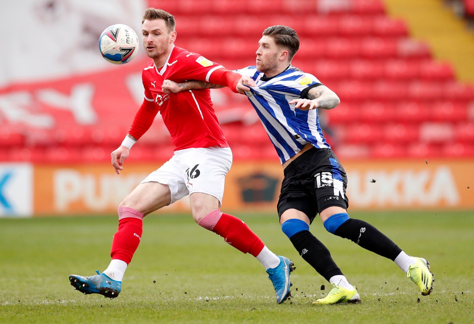 Soccer Football - Championship - Barnsley v Sheffield Wednesday - Oakwell, Barnsley, Britain - March 20, 2021 Barnsley's Michael Sollbauer in action with Sheffield Wednesday's Josh Windass Action Images/Andrew Boyers EDITORIAL USE ONLY. No use with unauthorized audio, video, data, fixture lists, club/league logos or 'live' services. Online in-match use limited to 75 images, no video emulation. No use in betting, games or single club /league/player publications.  Please contact your account repre