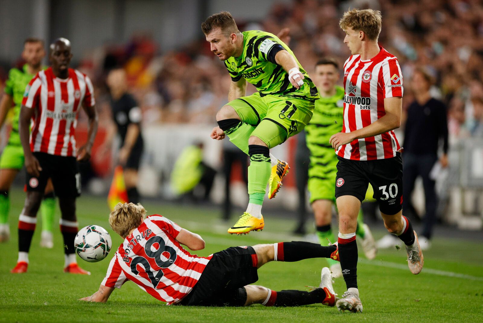 Soccer - England - Carabao Cup Second Round - Brentford v Forest Green Rovers - Community Stadium, London, Britain - August 24, 2021  Forest Green Rovers' Nicky Cadden in action with Brentford's Mads Bidstrup and Mads Roerslev Action Images via Reuters/John Sibley