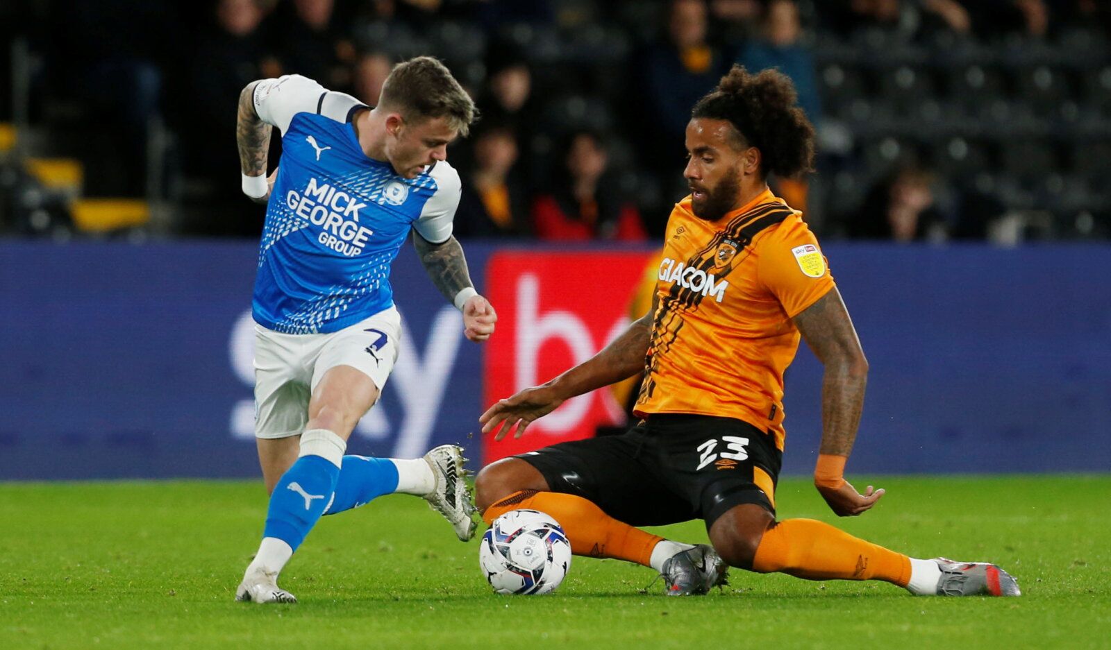Soccer Football - Championship - Hull City v Peterborough United - KCOM Stadium, Hull, Britain - October 20, 2021 Peterborough United's Sammie Szmodics (L) in action with Hull City's Tom Huddlestone   Action Images/Craig Brough  EDITORIAL USE ONLY. No use with unauthorized audio, video, data, fixture lists, club/league logos or 