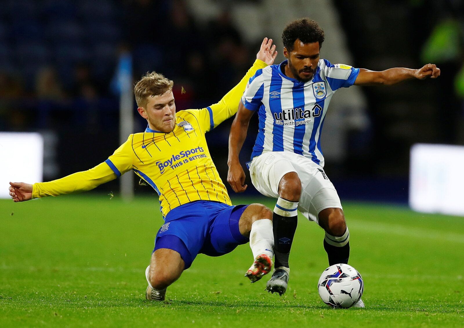 Soccer Football - Championship - Huddersfield Town v Birmingham City - John Smith's Stadium, Huddersfield, Britain - October 20, 2021  Birmingham City's Riley McGree in action with Huddersfield Town's Duane Holmes  Action Images/Jason Cairnduff  EDITORIAL USE ONLY. No use with unauthorized audio, video, data, fixture lists, club/league logos or 