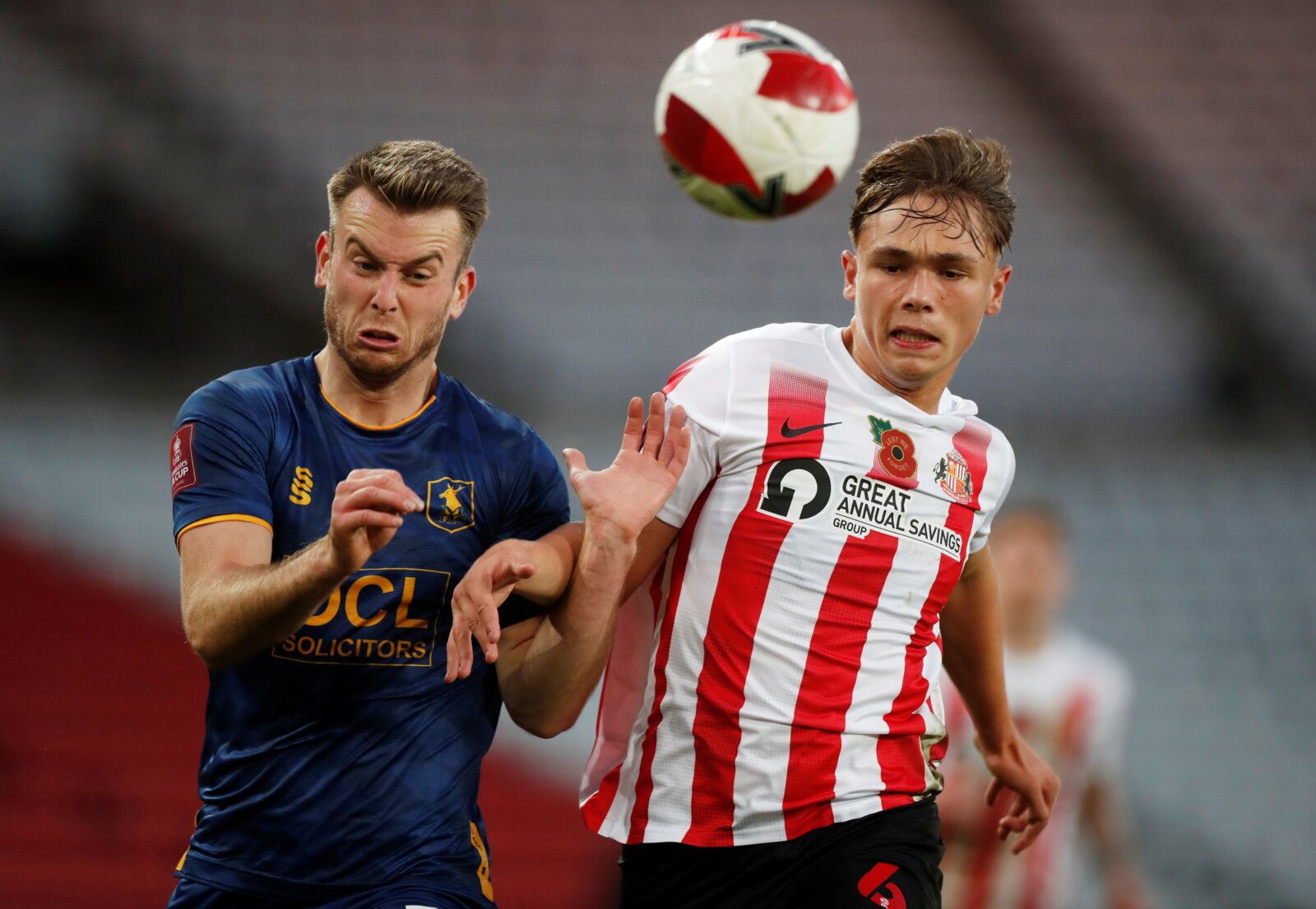 Soccer Football - FA Cup - First Round - Sunderland v Mansfield Town - Stadium of Light, Sunderland, Britain - November 6, 2021 Mansfield Town's Rhys Oates in action with Sunderland’s Callum Doyle   Action Images/Lee Smith