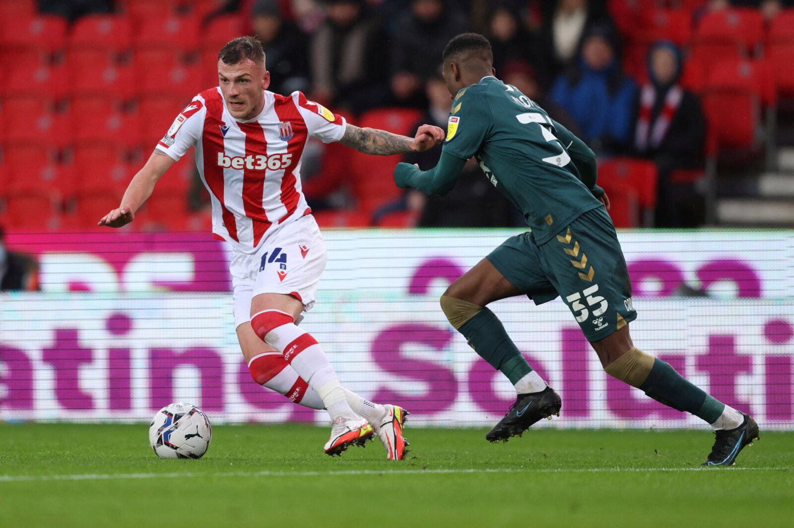 Soccer Football - Championship - Stoke City v Middlesbrough - bet365 Stadium, Stoke-on-Trent, Britain - December 11, 2021  Stoke City's Josh Tymon in action with Middlesbrough's Isaiah Jones  Action Images/John Clifton  EDITORIAL USE ONLY. No use with unauthorized audio, video, data, fixture lists, club/league logos or 