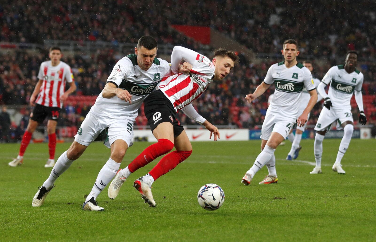 Soccer Football - League One- Sunderland v Plymouth Argyle - Stadium of Light, Sunderland, Britain - December 11, 2021  Sunderland's Dan Neil in action with Plymouth's James Wilson   Action Images/Lee Smith  EDITORIAL USE ONLY. No use with unauthorized audio, video, data, fixture lists, club/league logos or 
