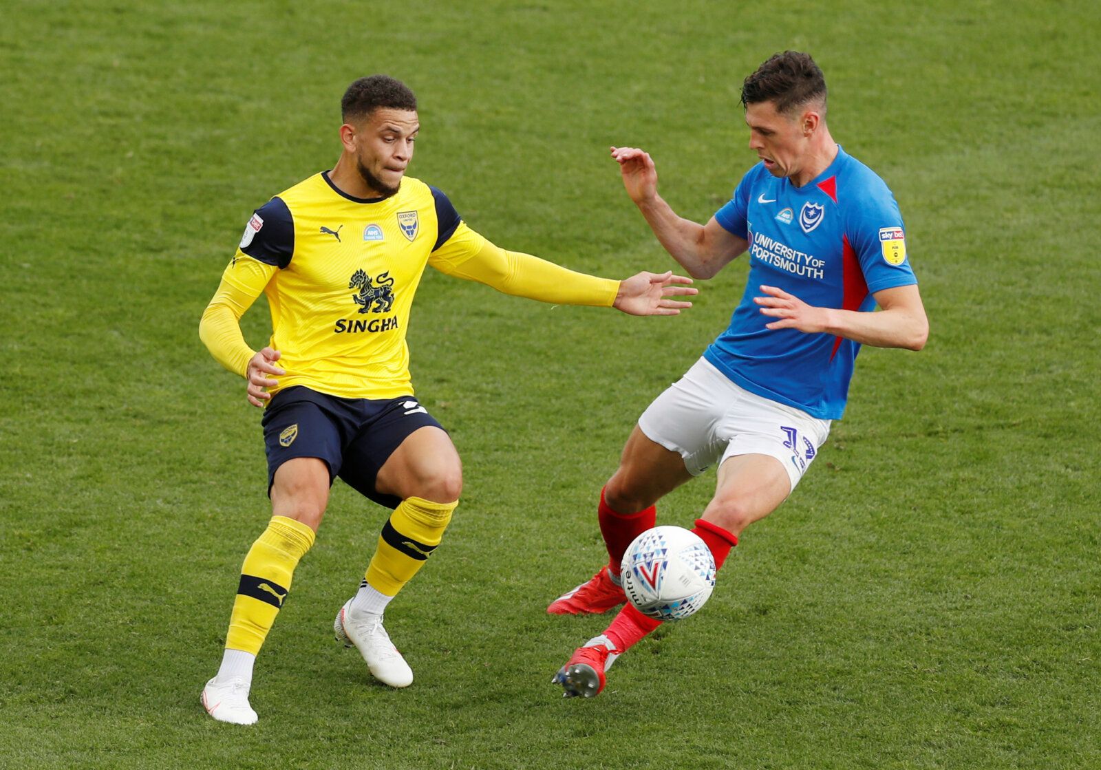 Soccer Football - League One Play Off Semi Final Second Leg - Oxford United v Portsmouth - Kassam Stadium, Oxford, Britain - July 6, 2020  Oxford's Marcus Browne in action with Portsmouth's James Bolton, as play resumes behind closed doors following the outbreak of the coronavirus disease (COVID-19)  Action Images/Matthew Childs  EDITORIAL USE ONLY. No use with unauthorized audio, video, data, fixture lists, club/league logos or 