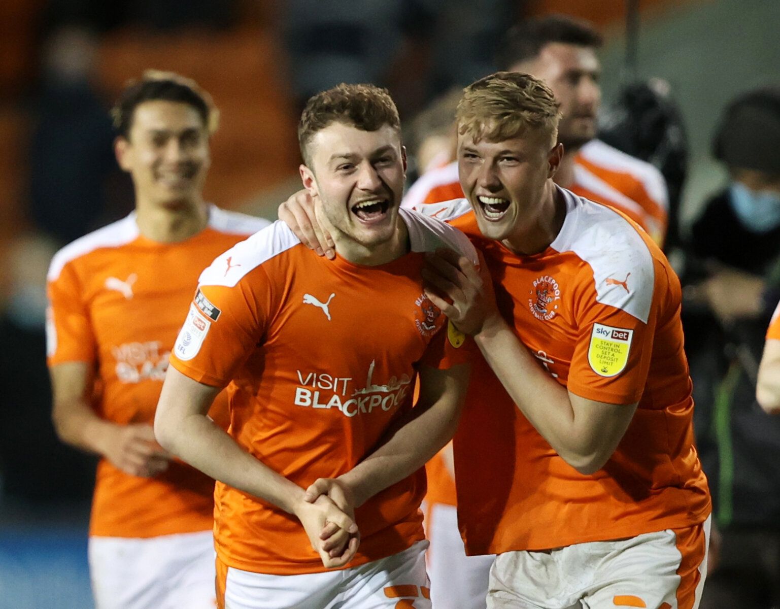 Soccer Football - League One Play-Off Semi Final Second Leg - Blackpool v Oxford United - Bloomfield Road Stadium, Blackpool, Britain - May 21, 2021 Blackpool's Eliot Embleton and Daniel Ballard celebrate with teammates after the match Action Images/Molly Darlington EDITORIAL USE ONLY. No use with unauthorized audio, video, data, fixture lists, club/league logos or 'live' services. Online in-match use limited to 75 images, no video emulation. No use in betting, games or single club /league/playe