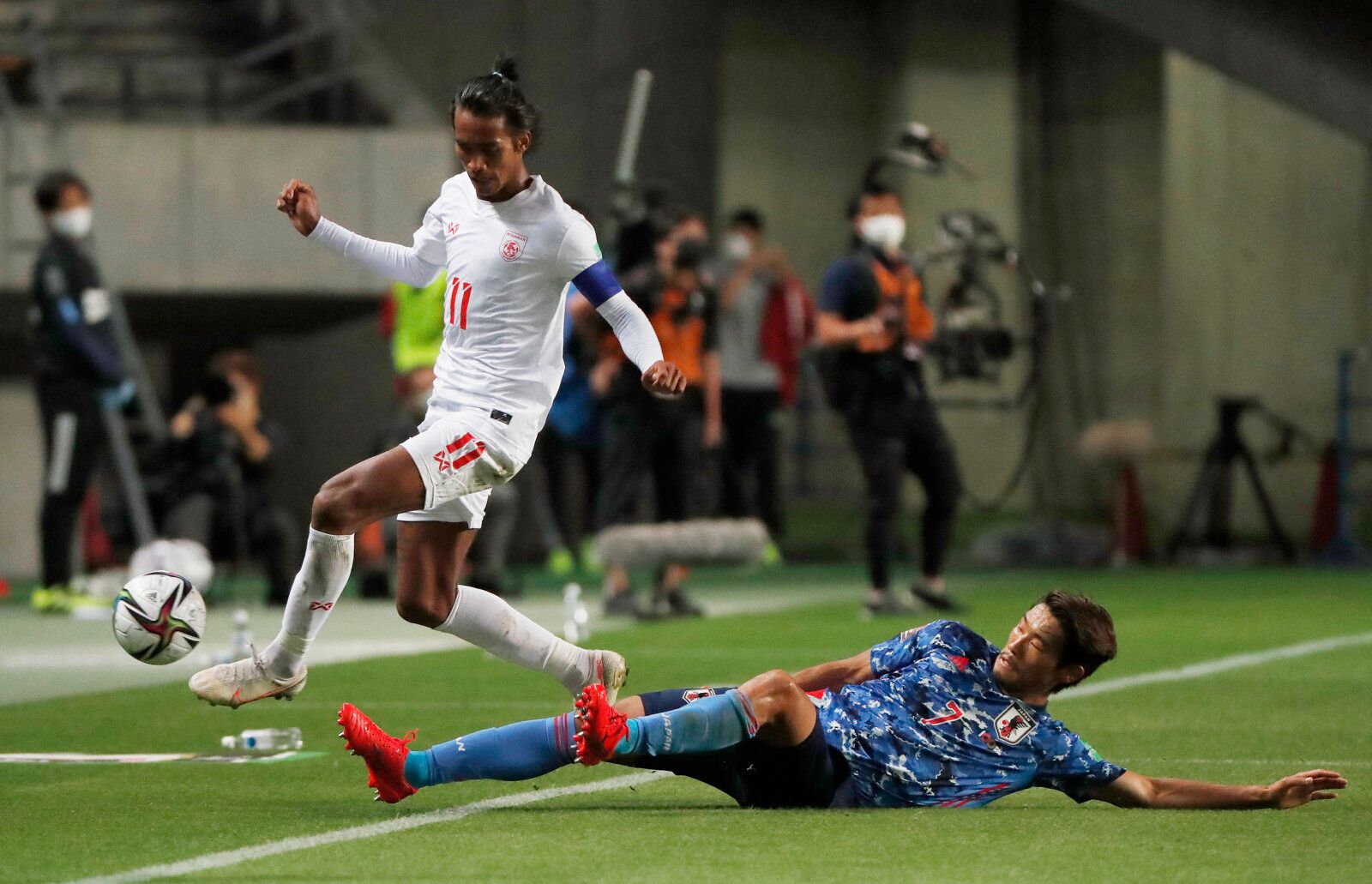 Soccer Football - World Cup - Asia Qualifiers - Second Round - Group F - Japan v Myanmar - Fukuda Denshi Arena, Chiba, Japan - May 28, 2021 Japan's Hidemasa Morita in action with Myanmar's Mg Mg Lwn REUTERS/Issei Kato
