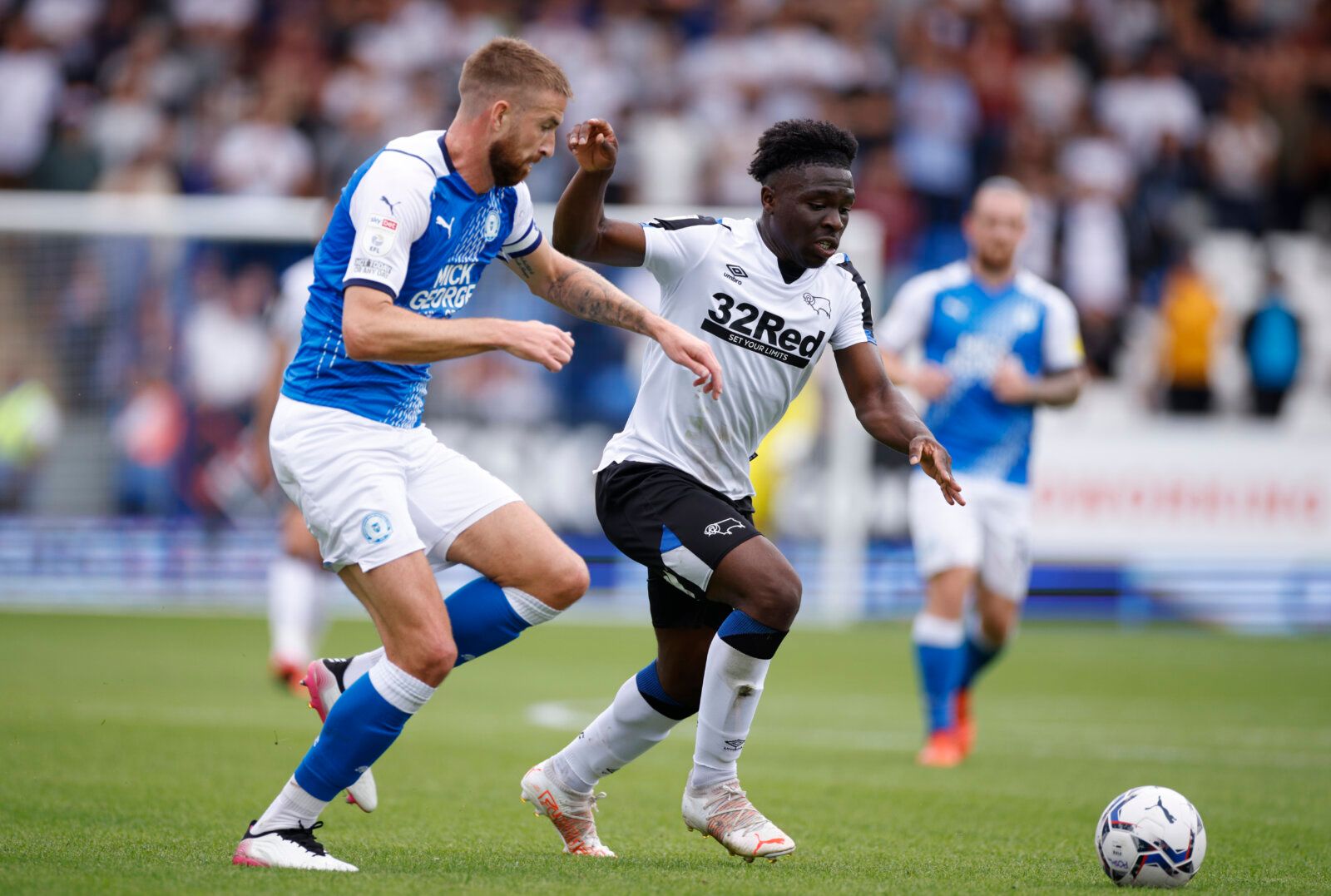 Soccer Football - Championship - Peterborough United v Derby County - Weston Homes Stadium, Peterborough, Britain - August 14, 2021 Derby County's Festy Ebosele in action with Peterborough United's Mark Beevers Action Images/John Sibley EDITORIAL USE ONLY. No use with unauthorized audio, video, data, fixture lists, club/league logos or 'live' services. Online in-match use limited to 75 images, no video emulation. No use in betting, games or single club /league/player publications.  Please contac