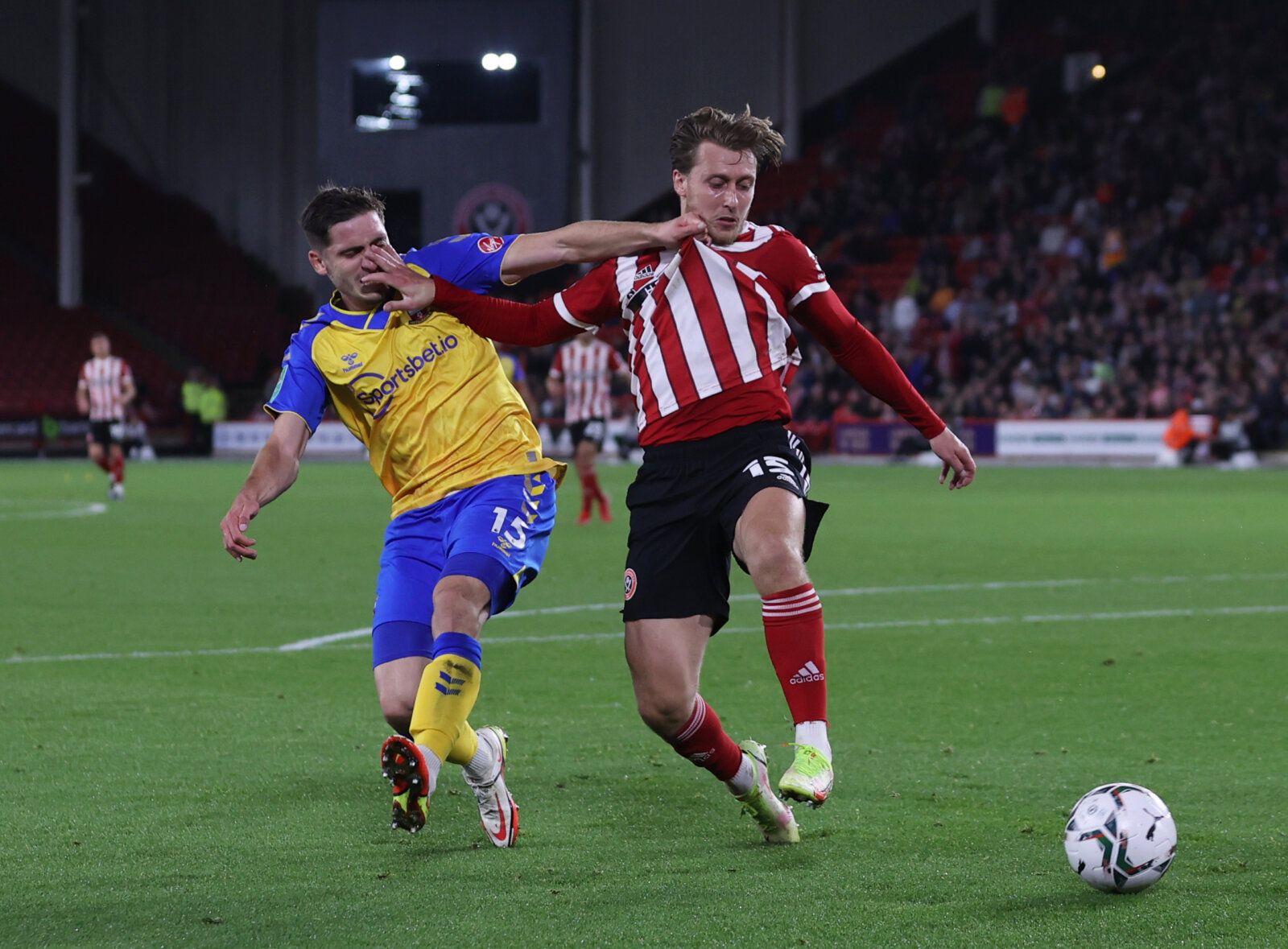 Soccer Football - Carabao Cup - Third Round - Sheffield United v Southampton - Bramall Lane, Sheffield, Britain - September 21, 2021 Southampton's Romain Perraud in action with Sheffield United's Luke Freeman Action Images via Reuters/Lee Smith EDITORIAL USE ONLY. No use with unauthorized audio, video, data, fixture lists, club/league logos or 'live' services. Online in-match use limited to 75 images, no video emulation. No use in betting, games or single club /league/player publications.  Pleas