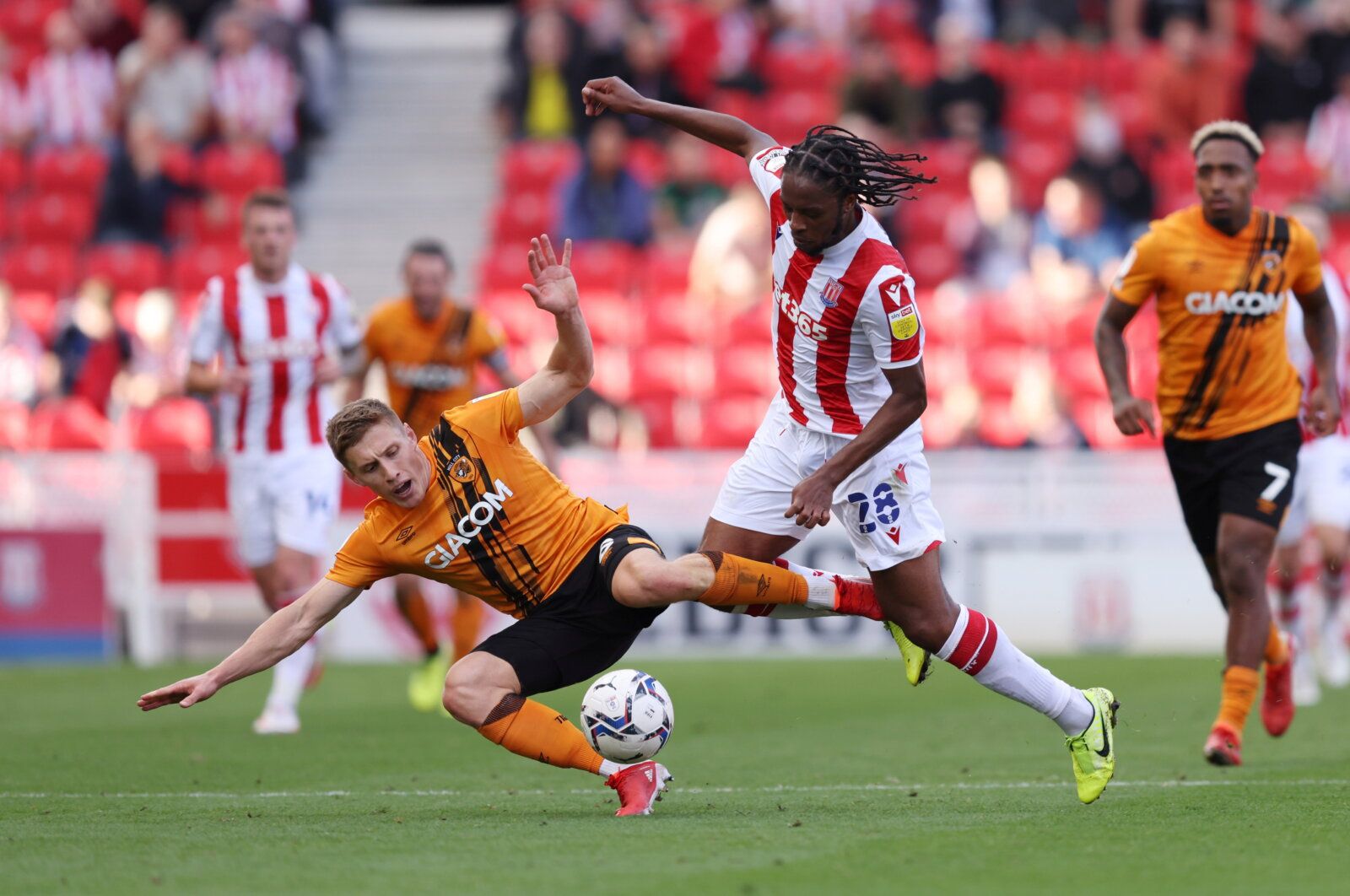 Soccer Football - England - Championship - Stoke City v Hull City - bet365 Stadium, Stoke-on-Trent, Britain - September 25, 2021  Hull City's Greg Docherty in action with Stoke City's Romaine Sawyers  Action Images/John Clifton   EDITORIAL USE ONLY. No use with unauthorized audio, video, data, fixture lists, club/league logos or 