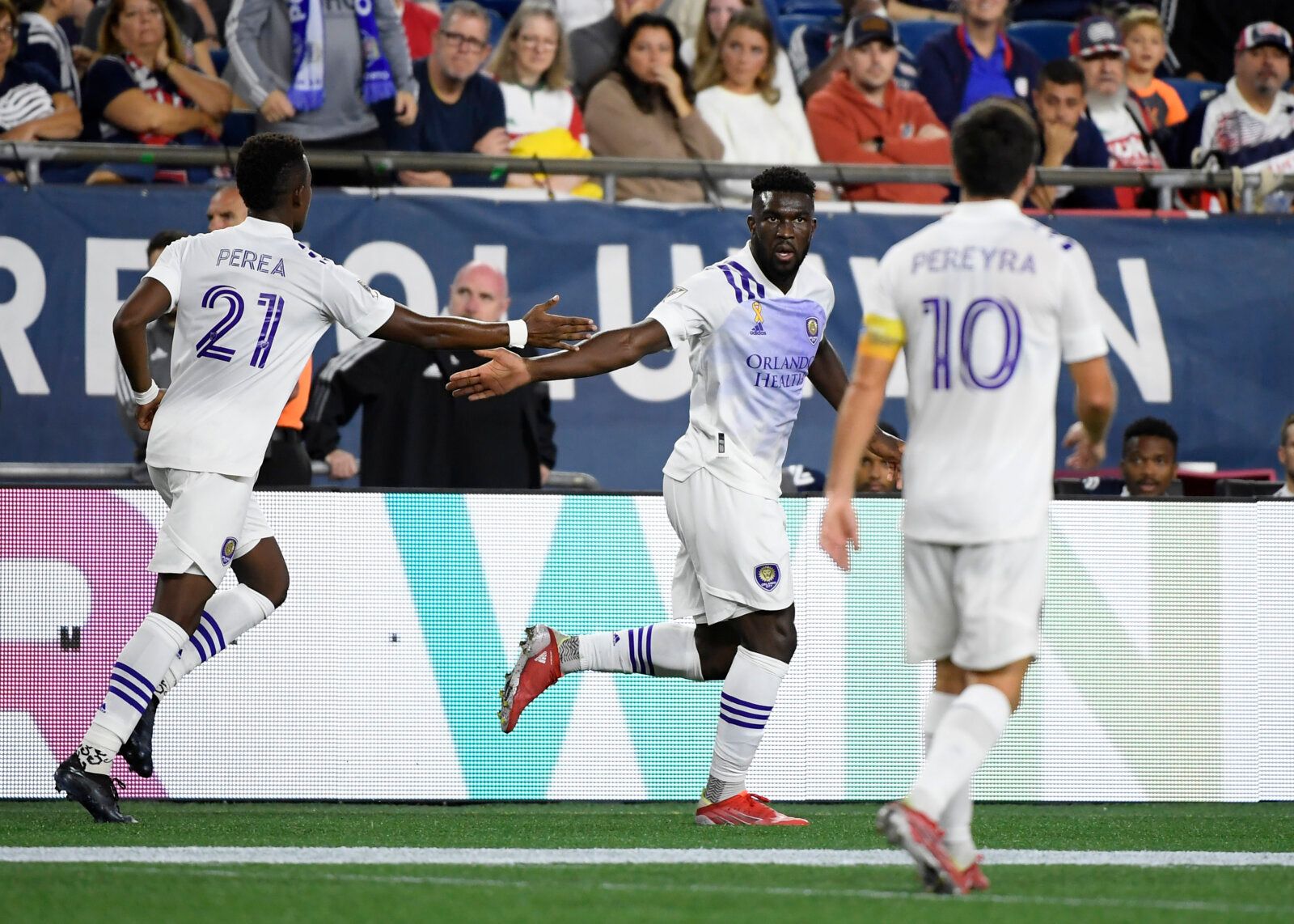 Sep 25, 2021; Foxborough, Massachusetts, USA; Orlando City SC forward Daryl Dike (18) celebrates with midfielder Andres Perea (21) after scoring a goal against the New England Revolution during the first half at Gillette Stadium. Mandatory Credit: Bob DeChiara-USA TODAY Sports