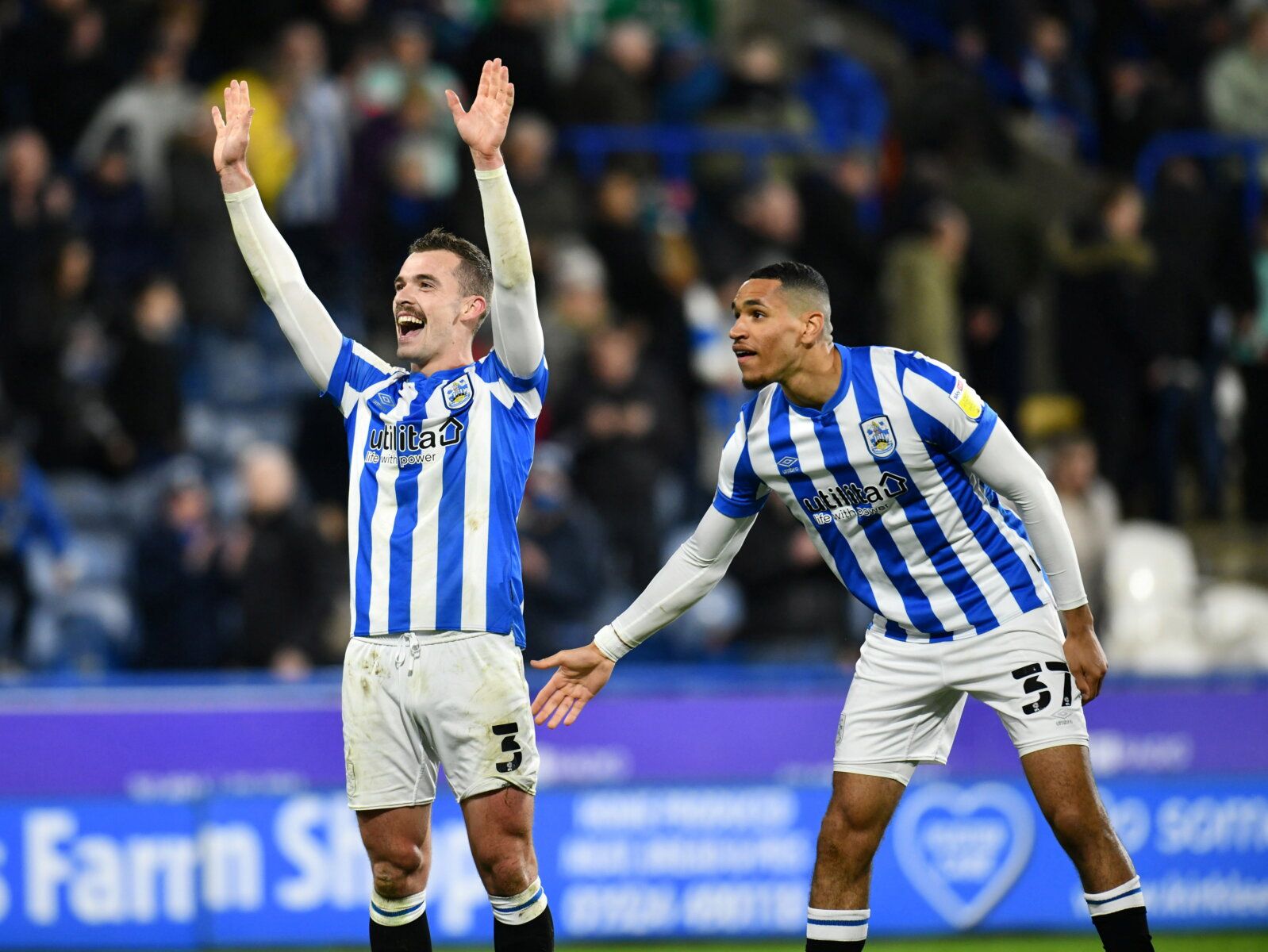 Soccer Football - Championship - Huddersfield Town v West Bromwich Albion - John Smith's Stadium, Huddersfield, Britain - November 20, 2021 Huddersfield Town's Harry Toffolo and Jon Russell celebrates after the match         Paul Burrows/Action Images