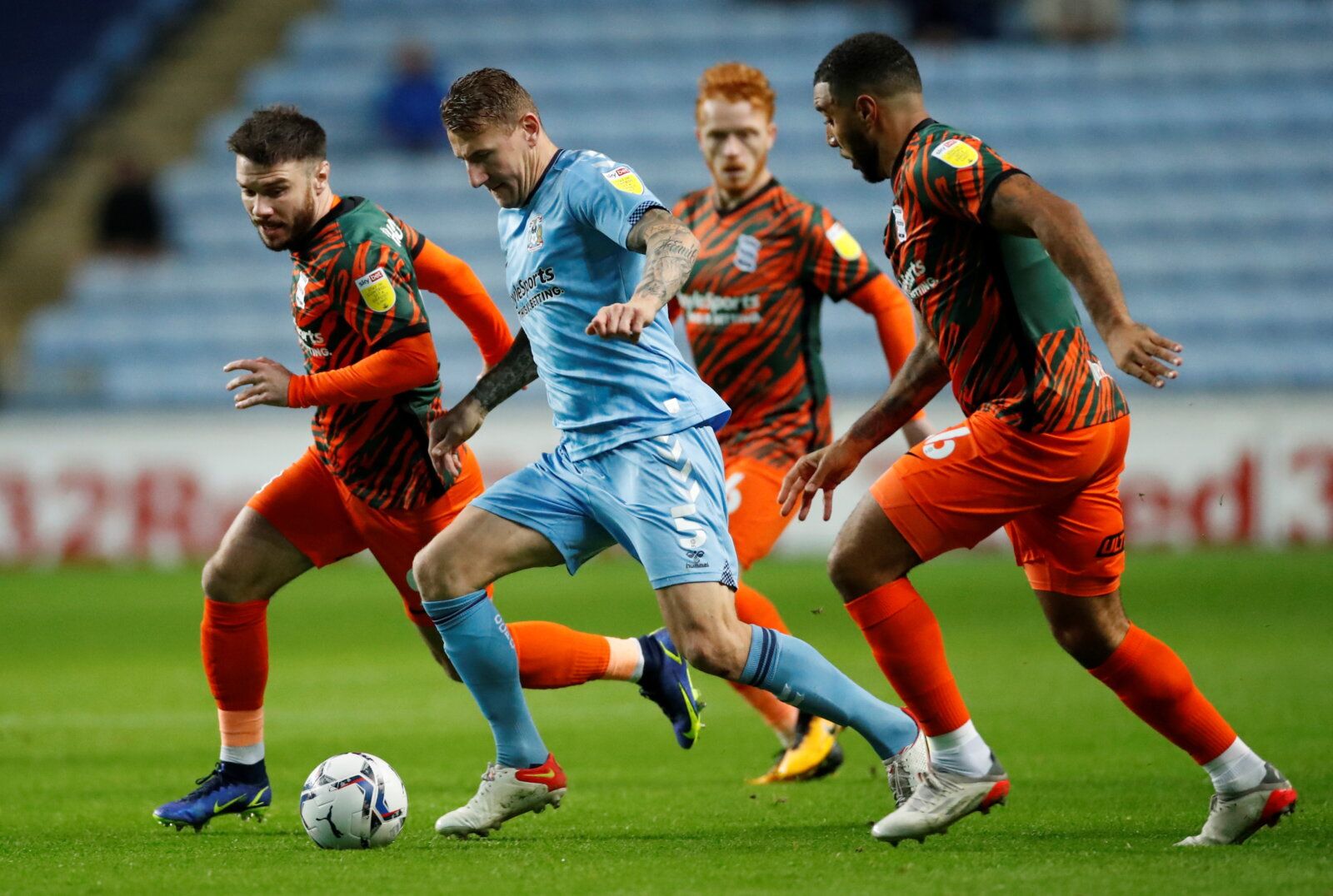 Soccer Football - Championship - Coventry City v Birmingham City - Building Society Arena, Coventry, Britain - November 23, 2021 Coventry City's Kyle McFadzean in action with Birmingham City's Scott Hogan and Troy Deeney Action Images/Andrew Boyers