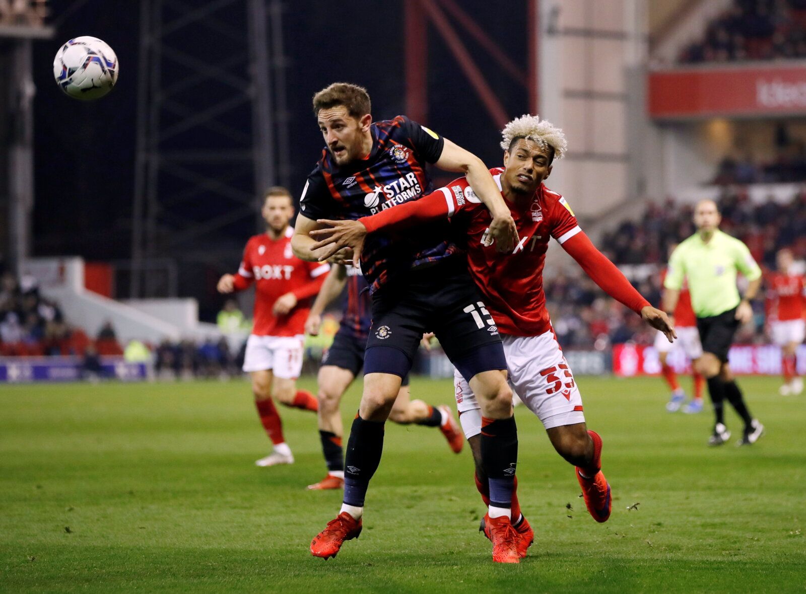 Soccer Football - Championship - Nottingham Forest v Luton Town - The City Ground, Nottingham, Britain - November 23, 2021 Nottingham Forest's Lyle Taylor in action with Luton Town's Tom Lockyer Action Images/Paul Childs