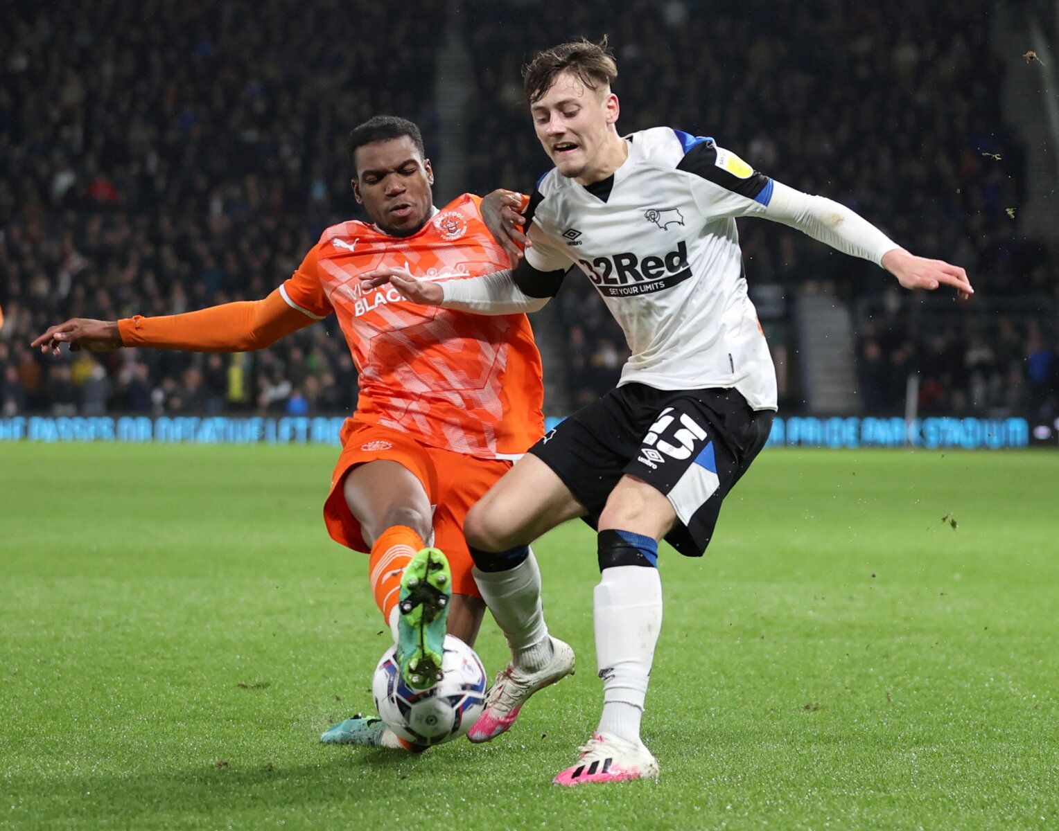 Soccer Football - Championship - Derby County v Blackpool - Pride Park, Derby, Britain - December 11, 2021  Blackpool's Dujon Sterling in action with Derby County's Dylan Williams Action Images/Molly Darlington  EDITORIAL USE ONLY. No use with unauthorized audio, video, data, fixture lists, club/league logos or 