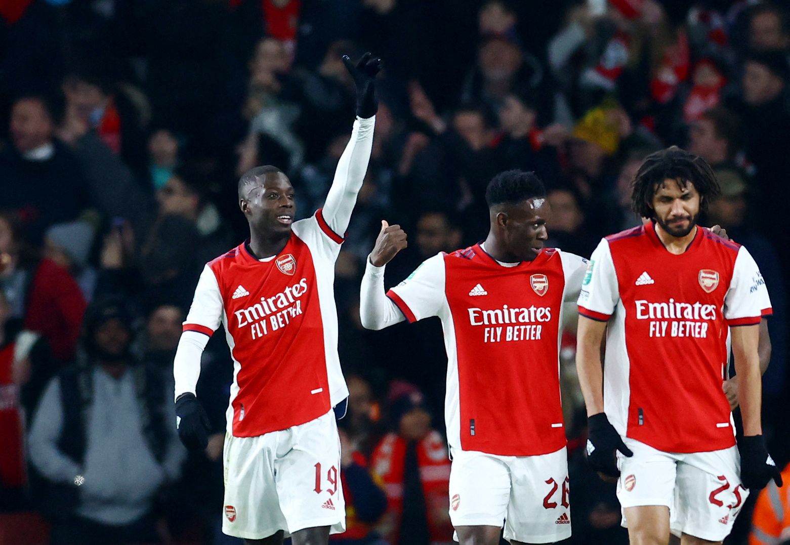 Soccer Football - Carabao Cup - Quarter Final - Arsenal v Sunderland - Emirates Stadium, London, Britain - December 21, 2021 Arsenal's Nicolas Pepe celebrates scoring their second goal with Folarin Balogun and Mohamed Elneny REUTERS/David Klein EDITORIAL USE ONLY. No use with unauthorized audio, video, data, fixture lists, club/league logos or 'live' services. Online in-match use limited to 75 images, no video emulation. No use in betting, games or single club /league/player publications.  Pleas