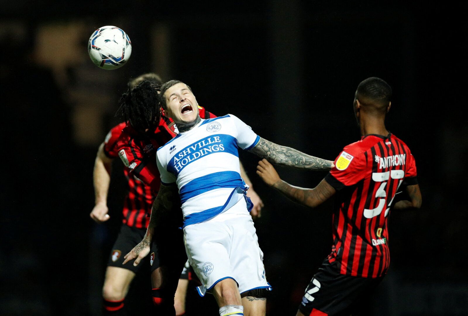 Soccer Football - Championship - Queens Park Rangers v AFC Bournemouth - Loftus Road, London, Britain - December 27, 2021 Queens Park Rangers' Lyndon Dykes in action with AFC Bournemouth's Jordan Zemura  Action Images/Andrew Boyers  EDITORIAL USE ONLY. No use with unauthorized audio, video, data, fixture lists, club/league logos or 