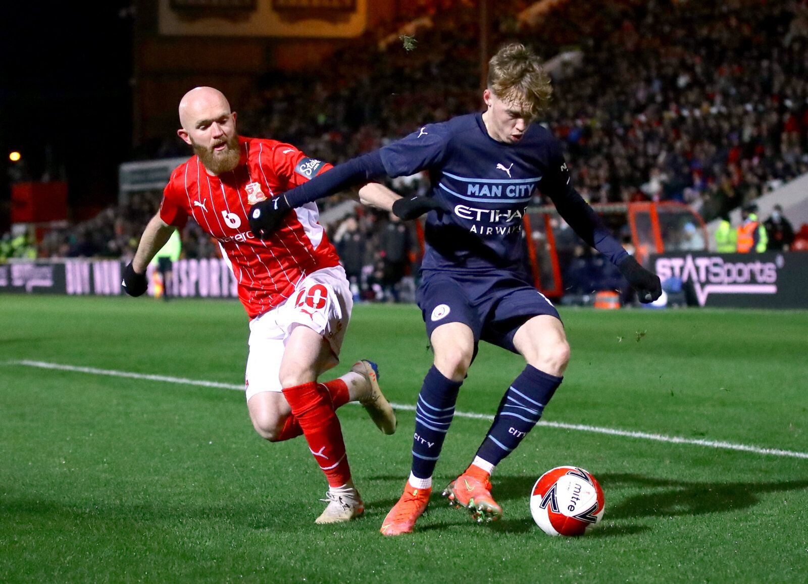 Soccer Football - FA Cup Third Round - Swindon Town v Manchester City - County Ground, Swindon, Britain - January 7, 2022 Manchester City's Cole Palmer in action with Swindon Town's Jonny Williams REUTERS/David Klein
