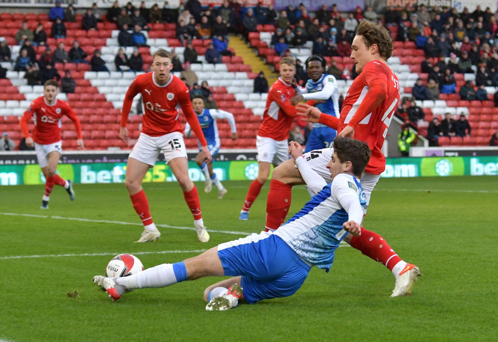Soccer Football - FA Cup Third Round - Barnsley v Barrow - Oakwell, Barnsley, Britain - January 8, 2022 Barnsley's Callum Styles in action with Barrow's Anthony Driscoll-Glennon Action Images/Paul Burrows