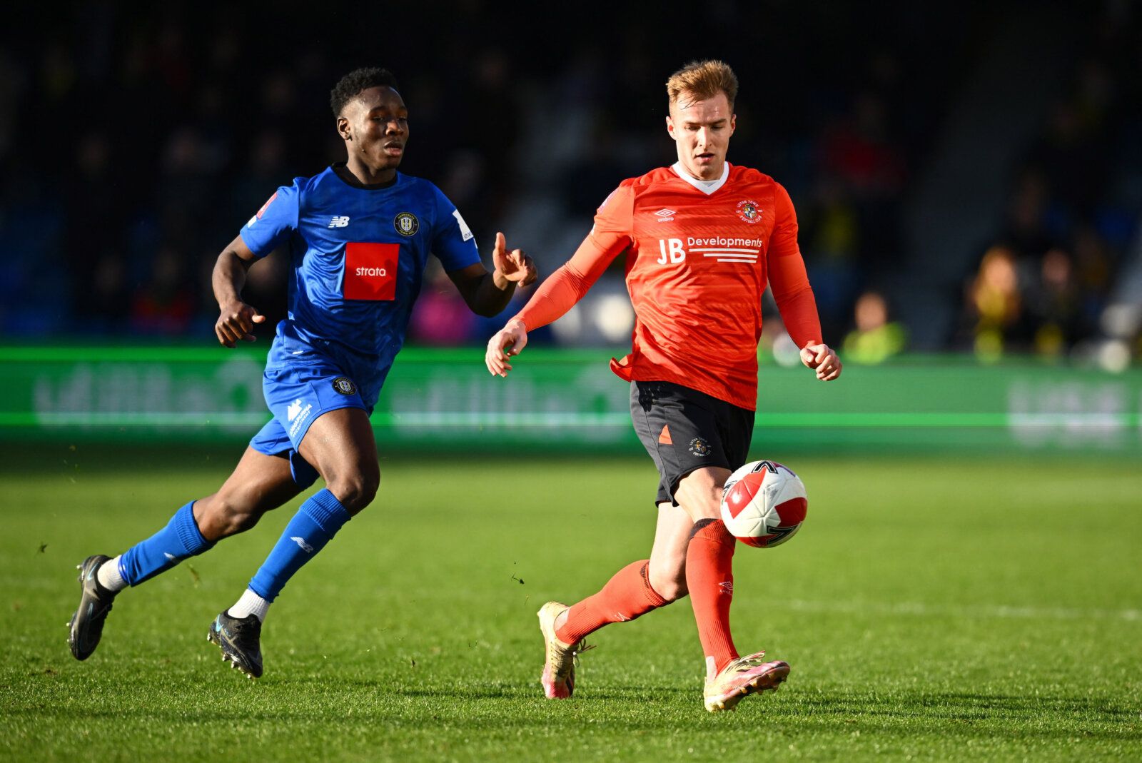 Soccer Football - FA Cup Third Round - Luton Town v Harrogate Town - Kenilworth Road, Luton, Britain - January 9, 2022 Harrogate Town's Brahima Diarra in action with Luton Town's James Bree REUTERS/Dylan Martinez