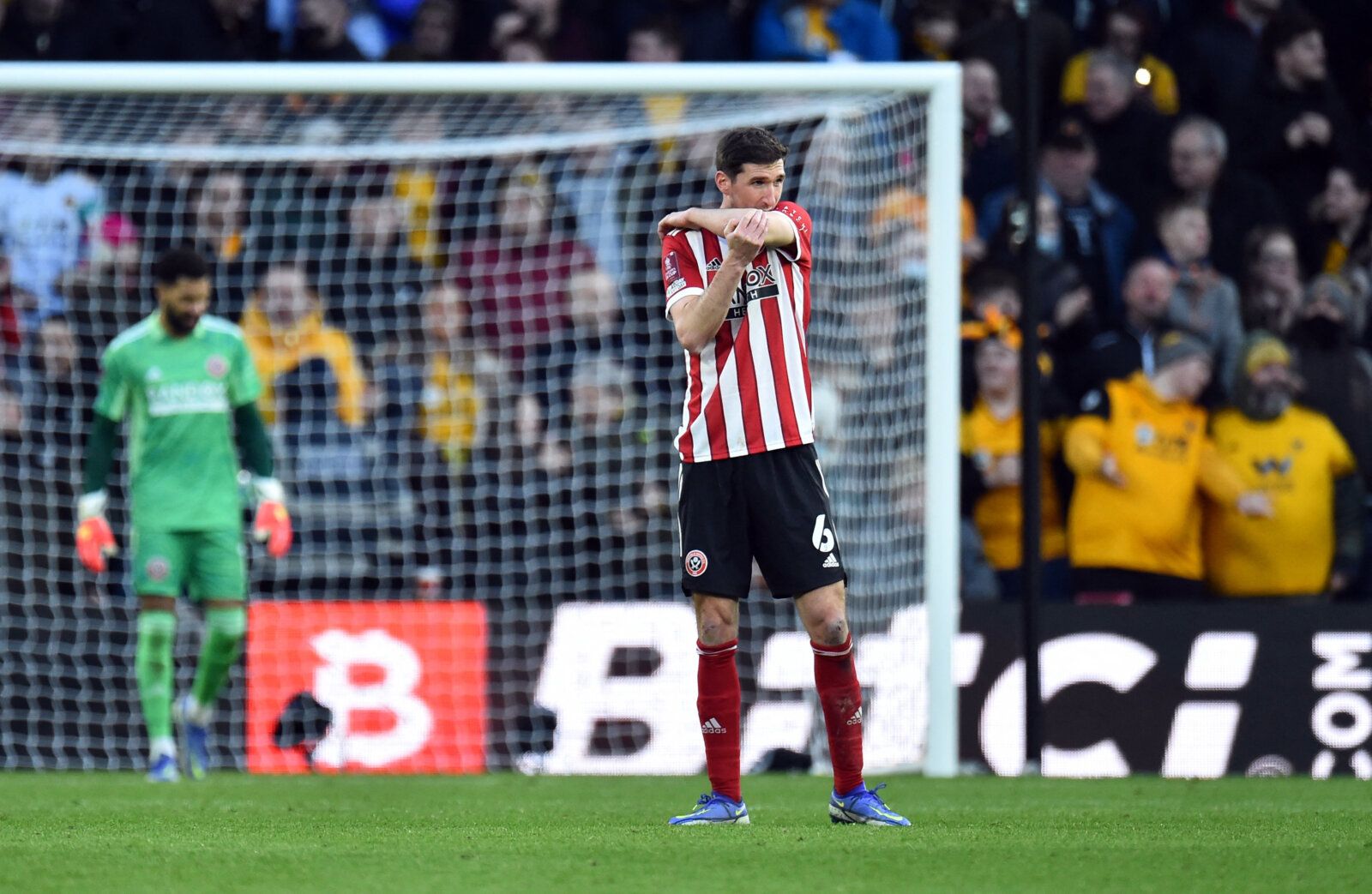 Soccer Football - FA Cup Third Round - Wolverhampton Wanderers v Sheffield United - Molineux Stadium, Wolverhampton, Britain - January 9, 2022 Sheffield United's Chris Basham looks dejected after Wolverhampton Wanderers' Nelson Semedo scores their second goal REUTERS/Peter Powell