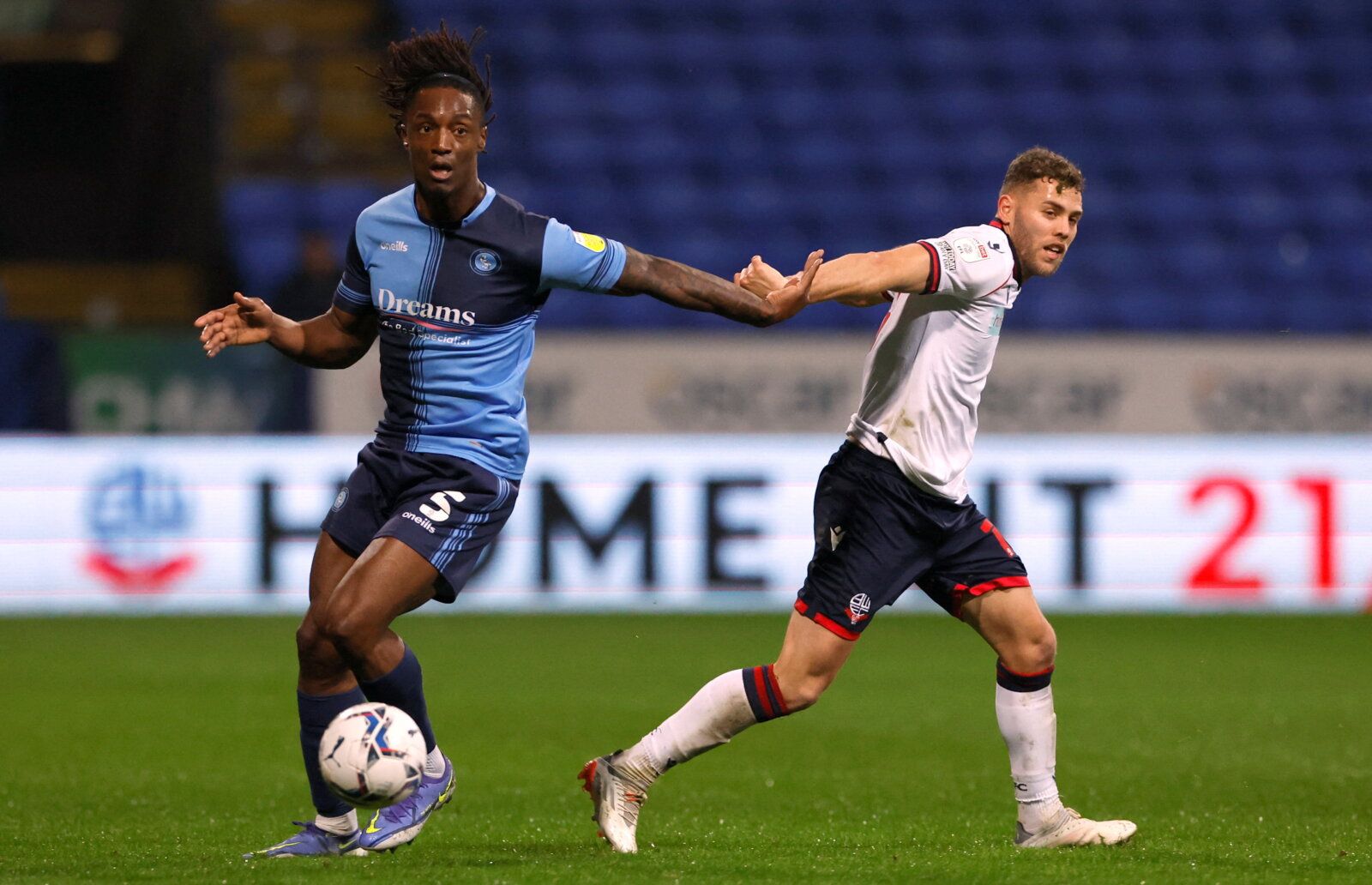 Soccer Football - League One - Bolton Wanderers v Wycombe Wanderers - University of Bolton Stadium, Bolton, Britain - January 11, 2022 Wycombe Wanderers' Anthony Stewart in action with Bolton Wanderers' Dion Charles   Action Images/Jason Cairnduff  EDITORIAL USE ONLY. No use with unauthorized audio, video, data, fixture lists, club/league logos or 